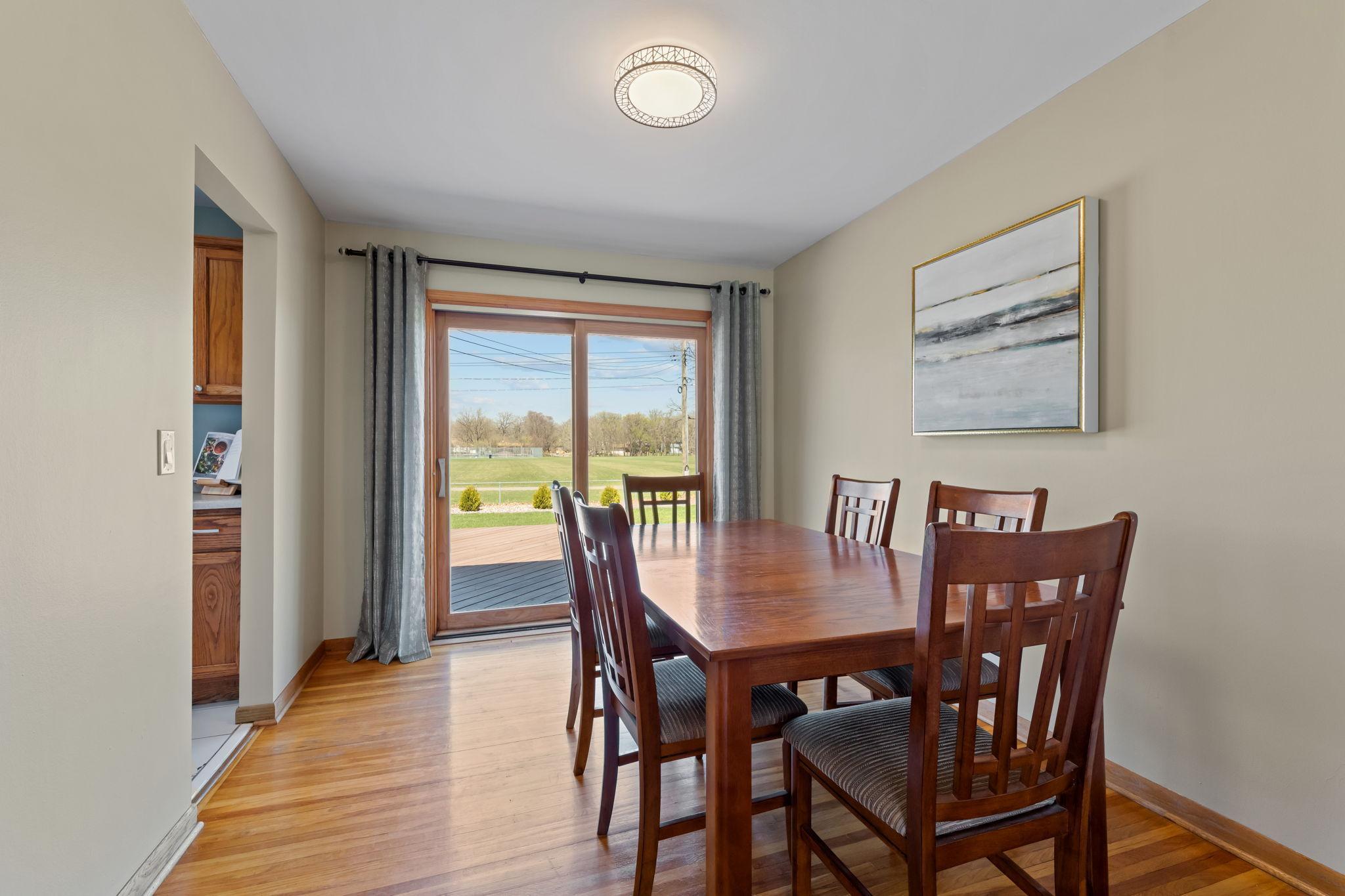 The dining room includes a sliding glass door that opens to a large deck and fenced backyard, perfectly positioned to overlook a park with no rear neighbors for added privacy and peace.