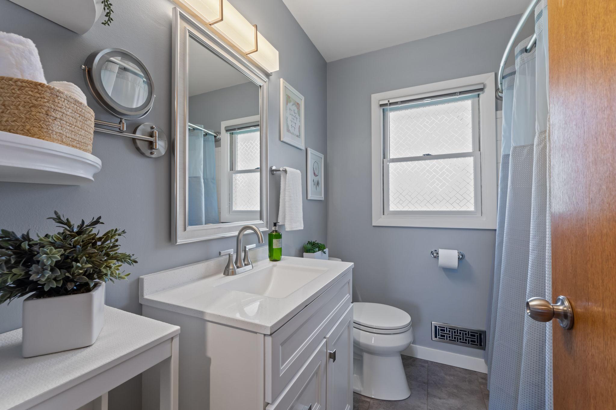 The main level includes a stylishly renovated full bathroom with modern updates.