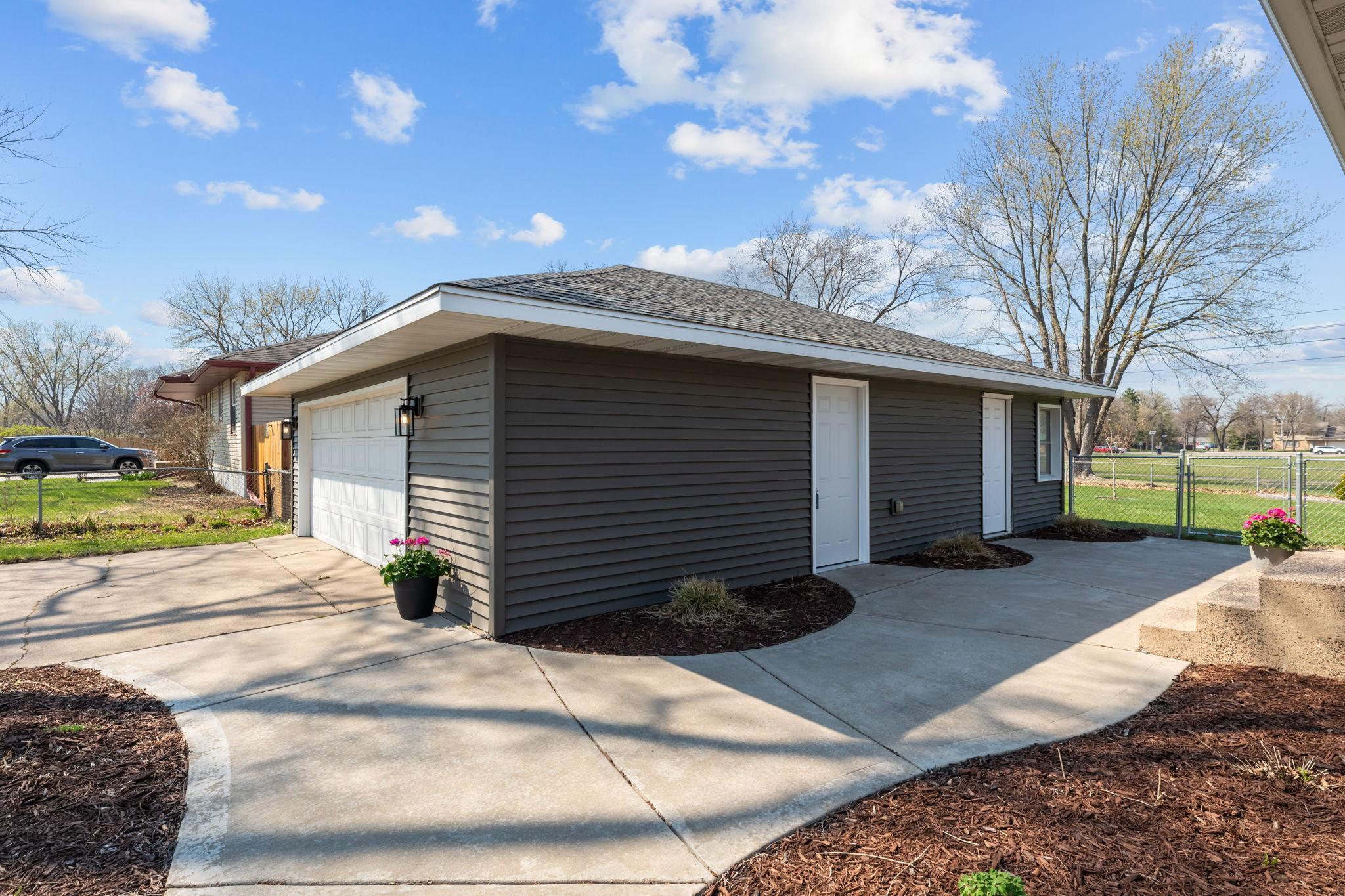 The oversized 2+ car garage includes a separate attached workshop/storage area, ideal for hobbies or extra storage.