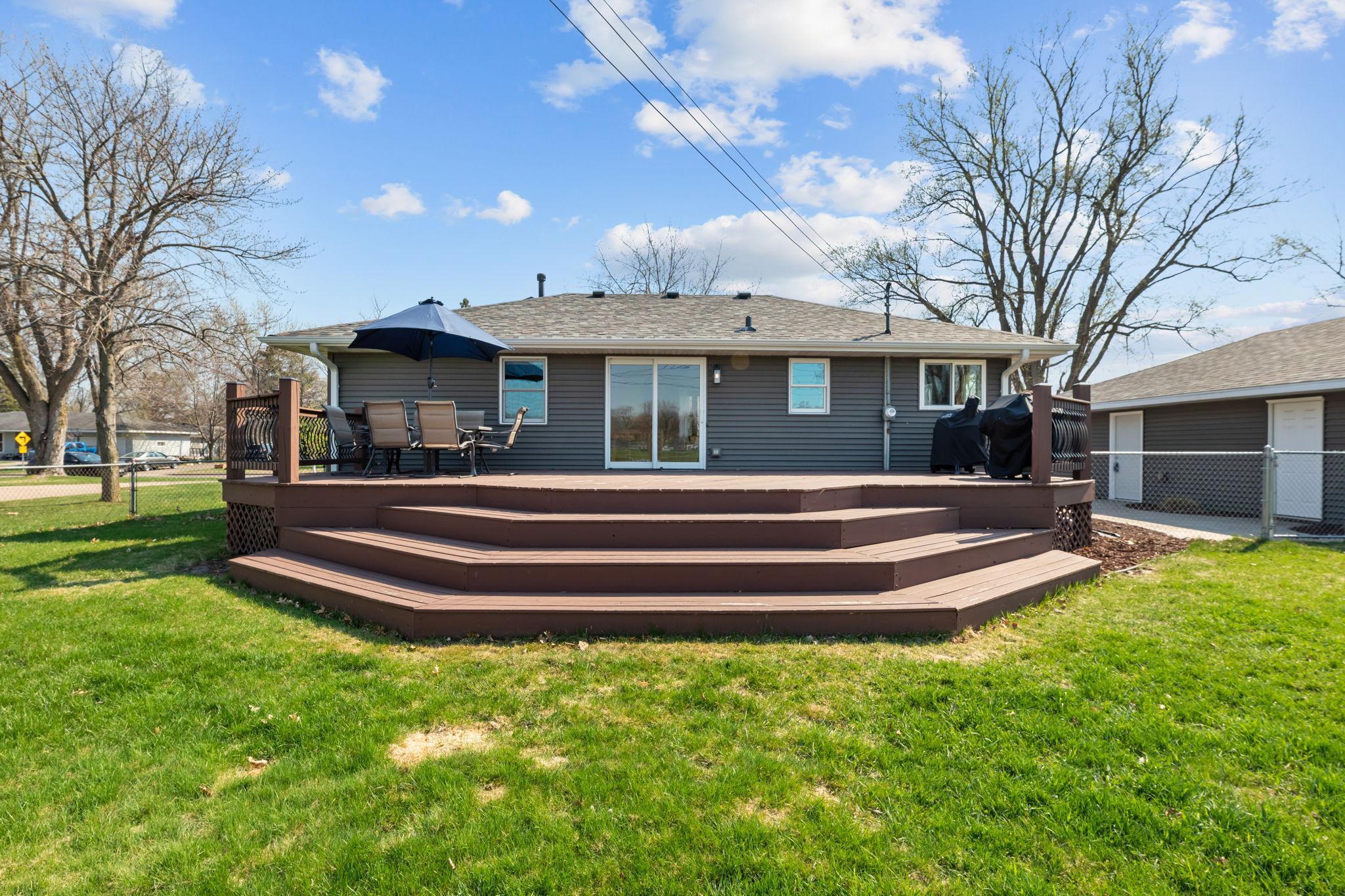 The expansive deck is perfect for entertaining, offering an ideal setting for summer BBQs and gatherings.