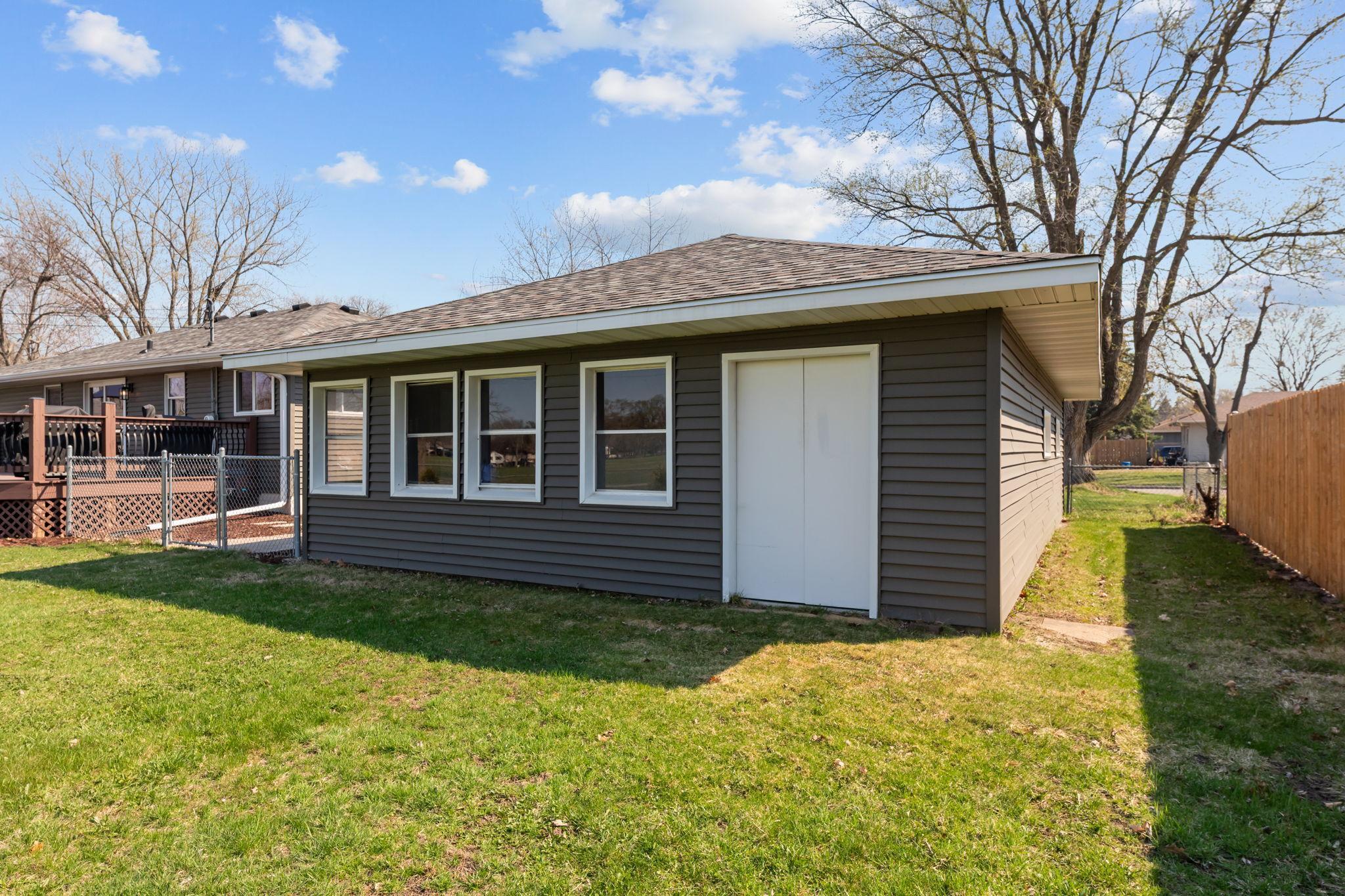 The garage includes a generous rear storage area with double-door access, providing an ideal solution for lawn equipment and effortless seasonal storage of patio furniture.