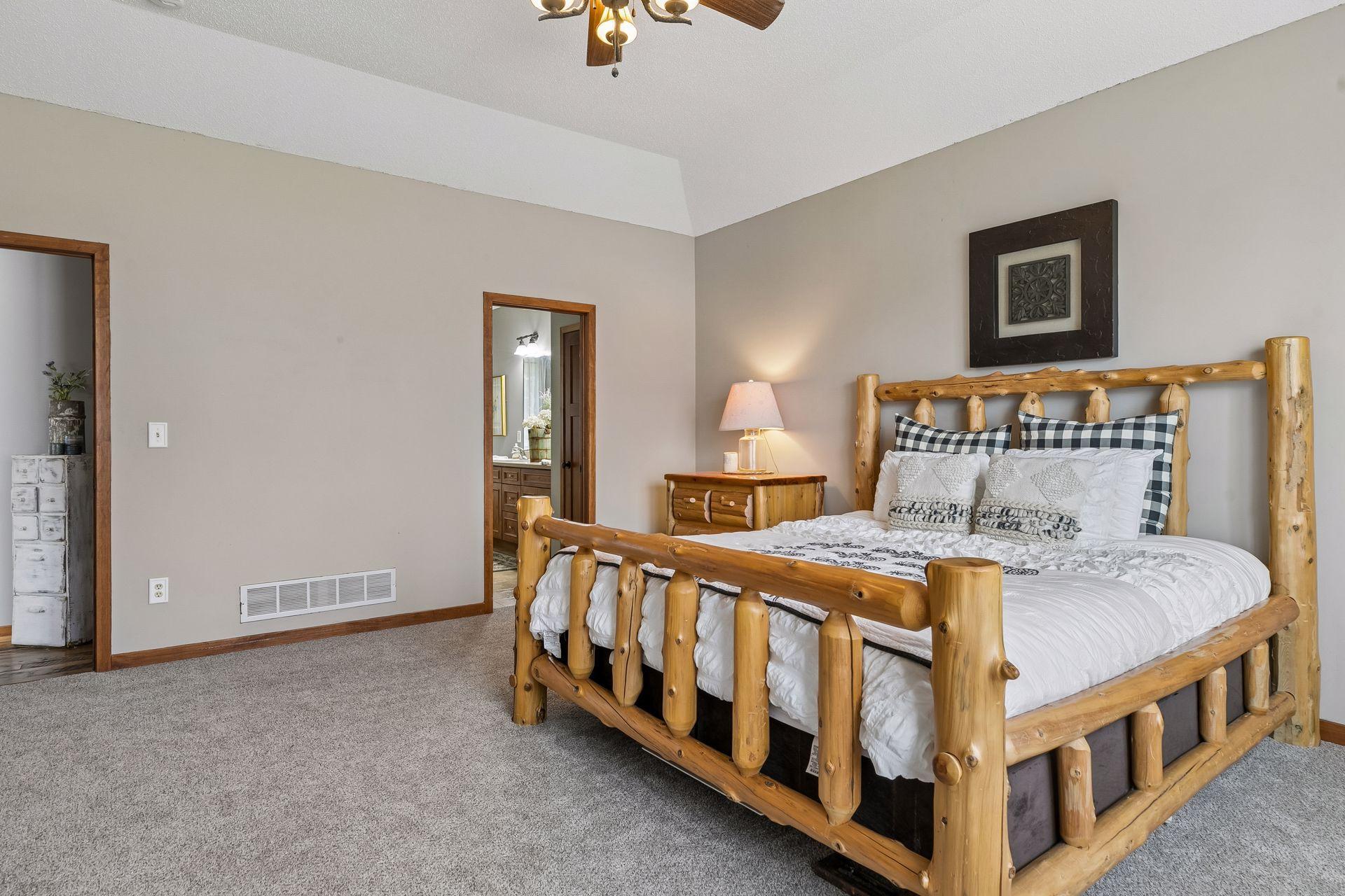 Spacious main floor Primary Bedroom with tray vault ceiling and new carpet.