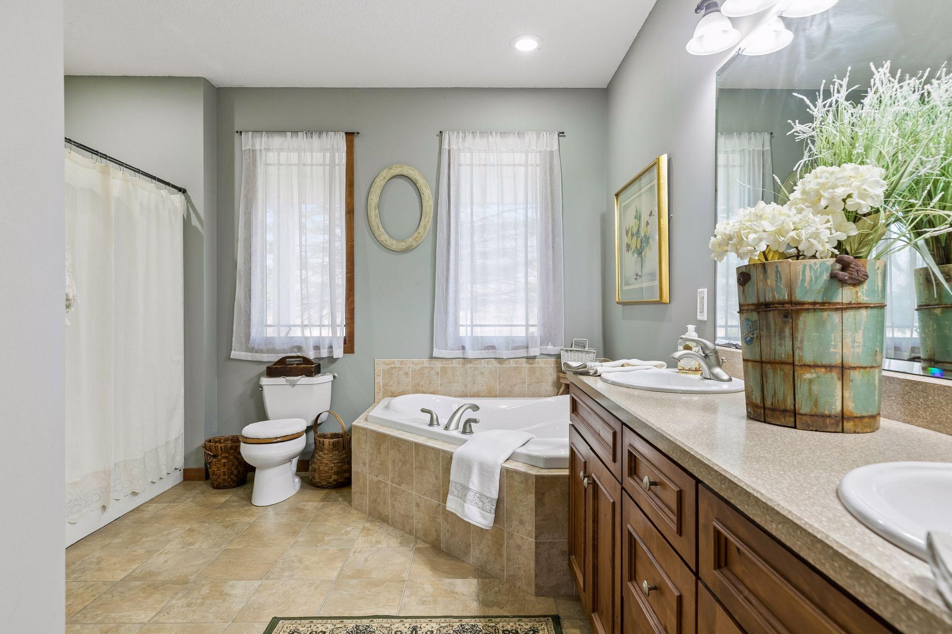 Private Primary Bath with corner Jacuzzi tub, separate shower, and double sinks.