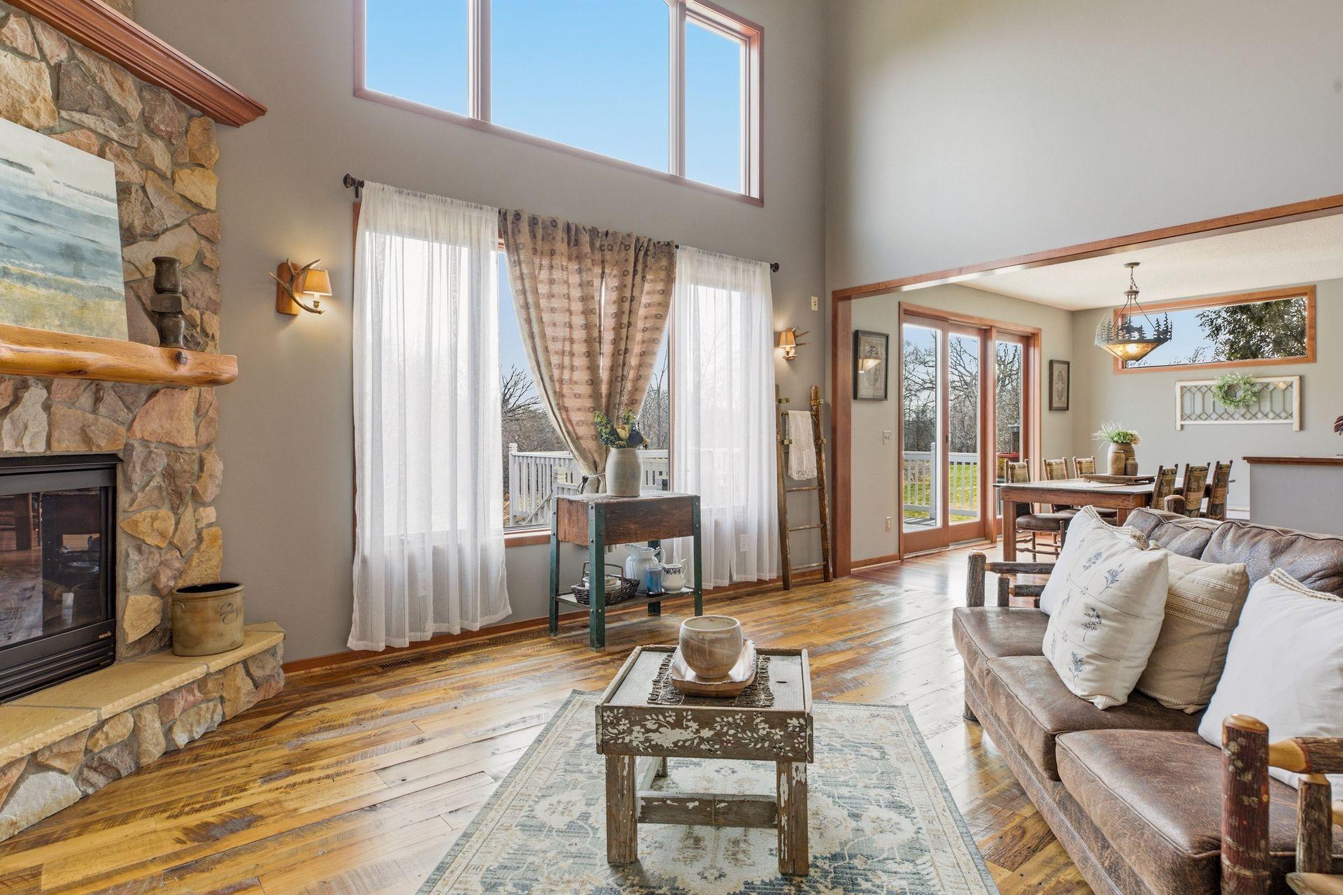 Floor-to-ceiling stone fireplace is a standout feature in the Great Room.