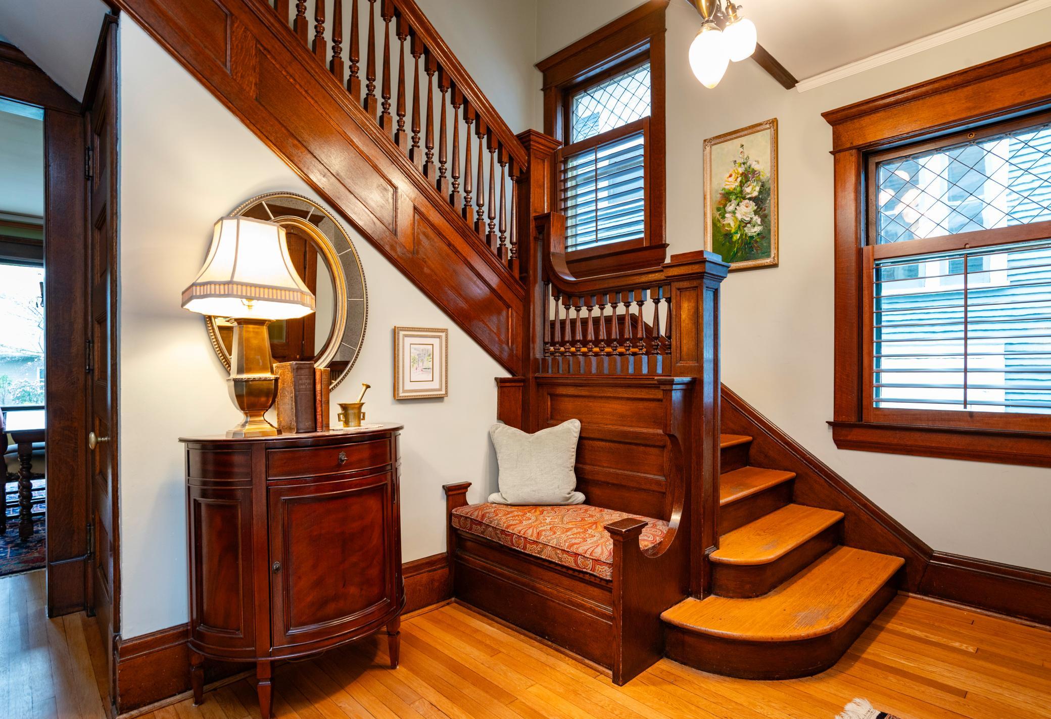 The foyer is filled with original, natural woodwork and a custom bench.