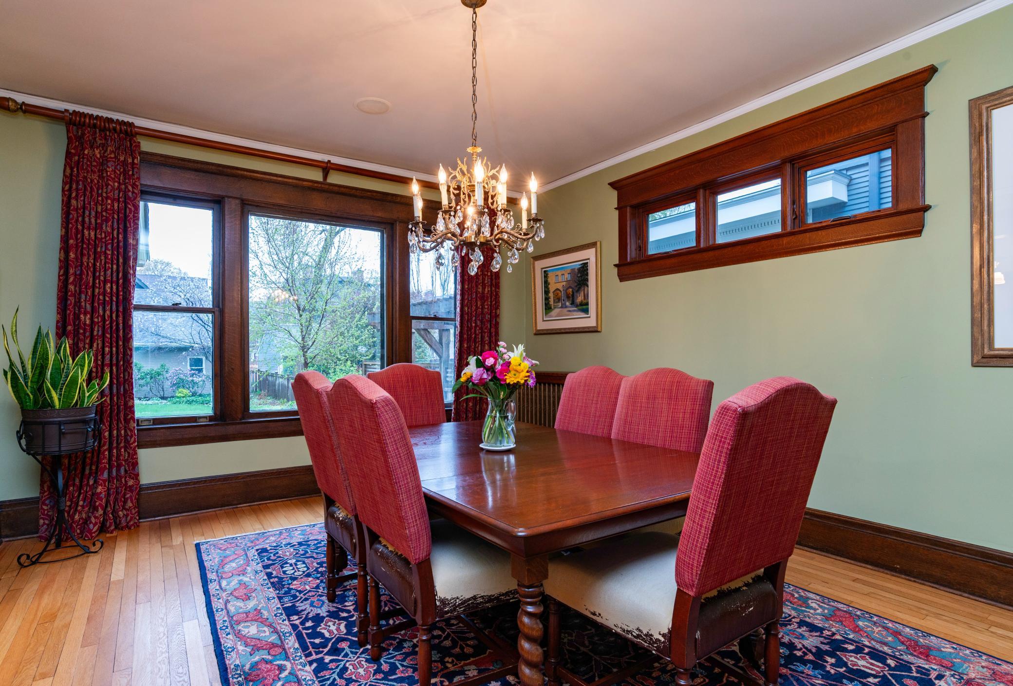 The south wall of the dining room boasts floor to ceiling windows filling this space with natural light!