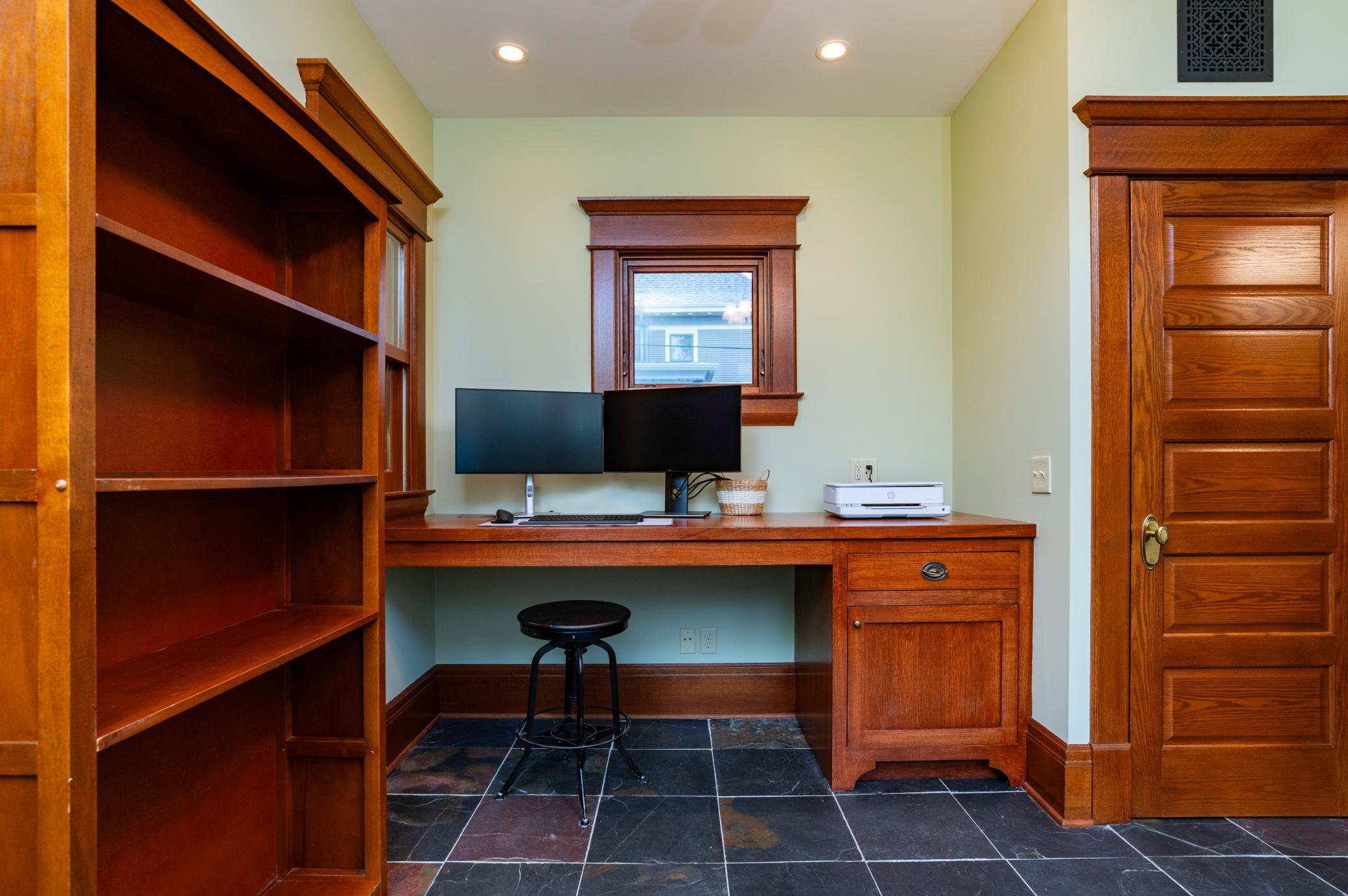 The rear addition to the home is the perfect den or office with a custom designed work station.