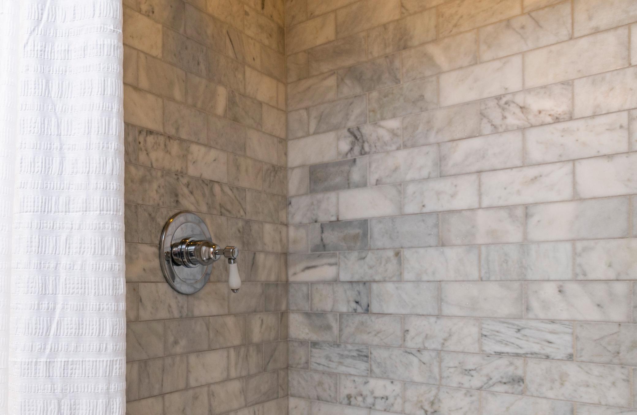 Marble tile in the walk-in primary suite shower.