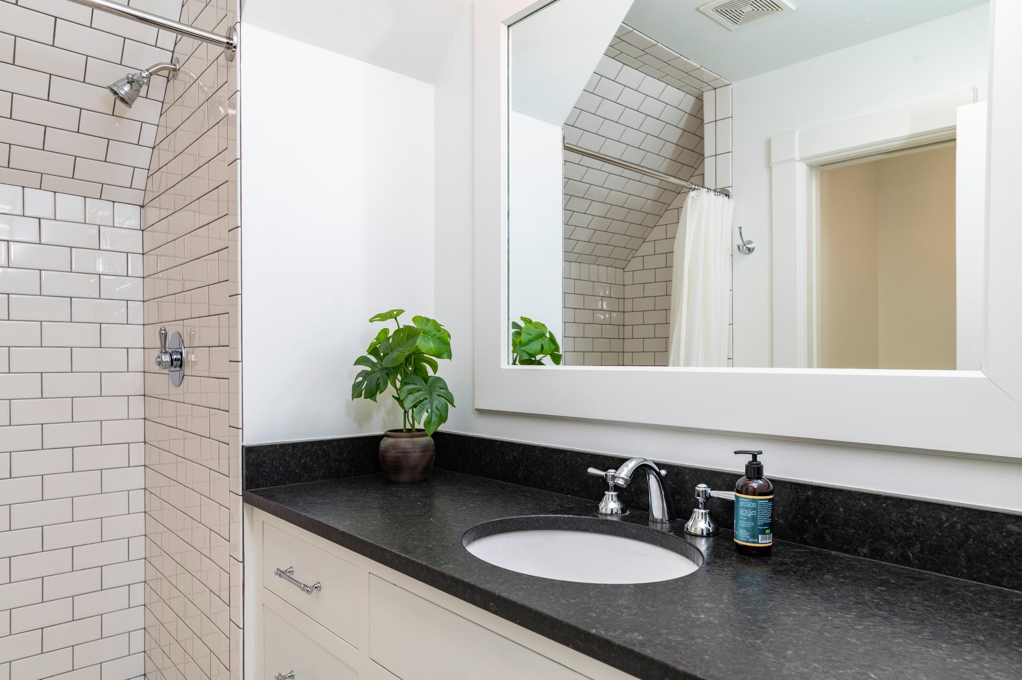 The updated third floor bathroom with separate water closet and stall shower.