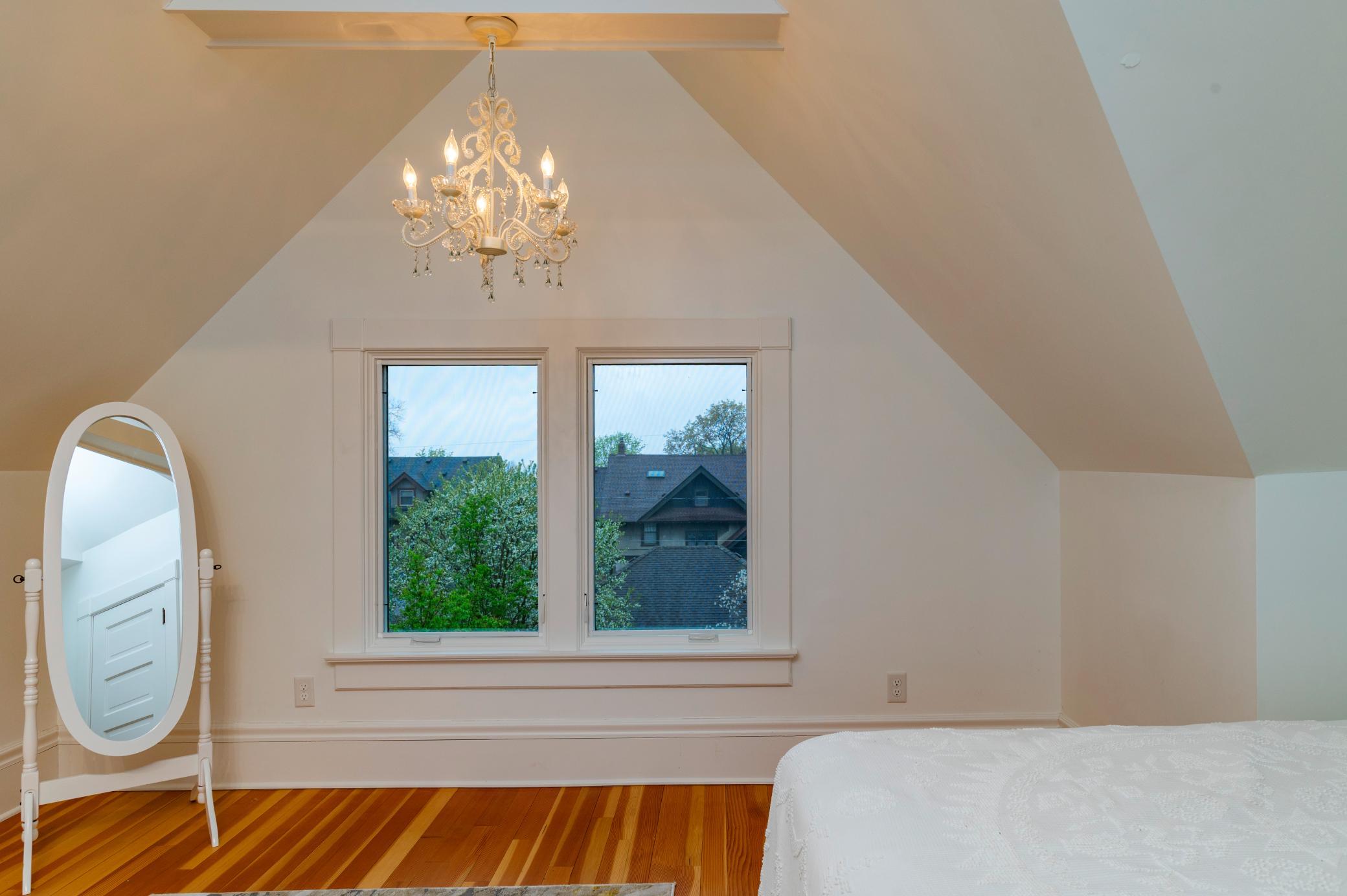 Both upper level rooms boast high vaulted ceilings.