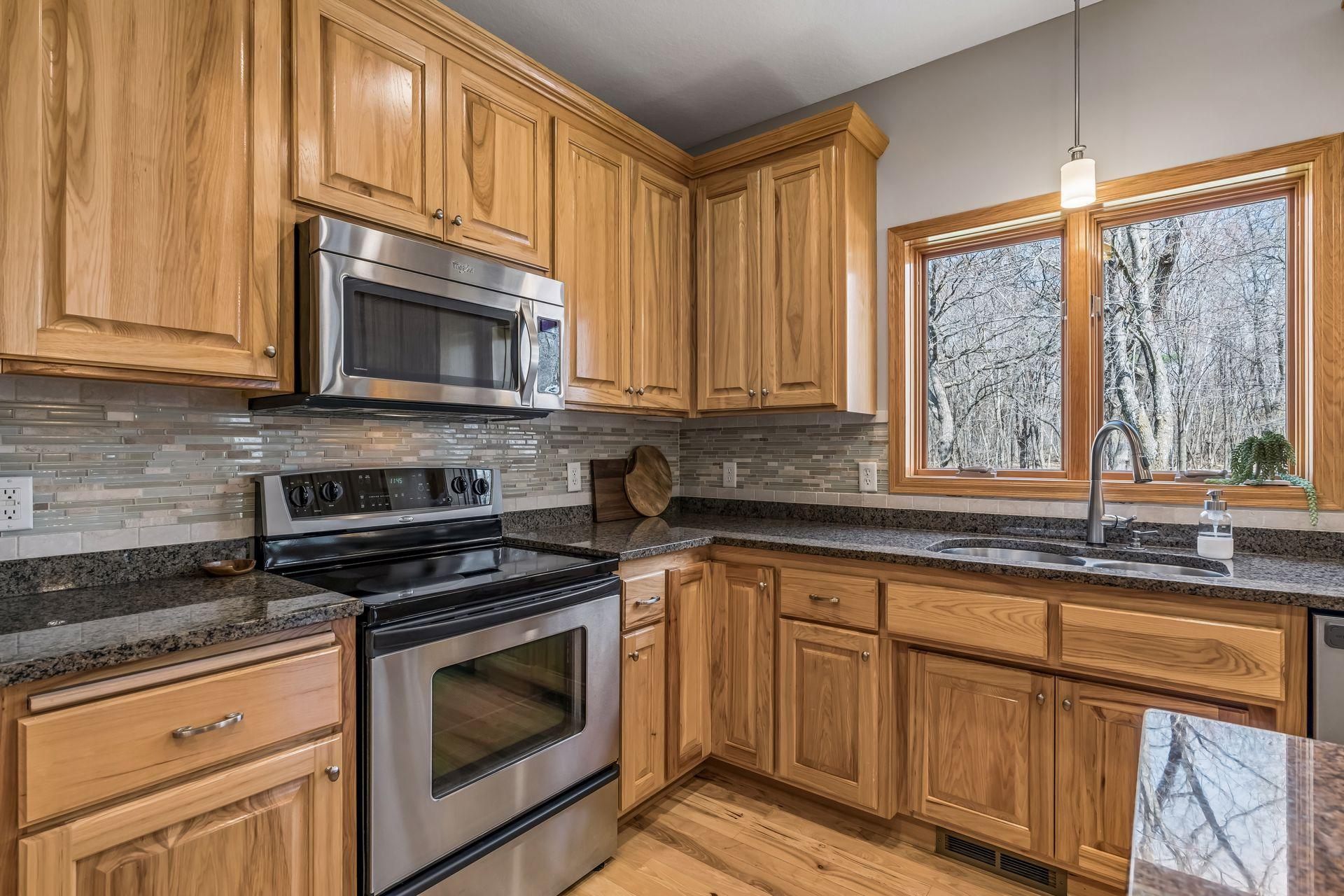 Custom tile backsplash and kitchen window to the backyard to watch the deer.