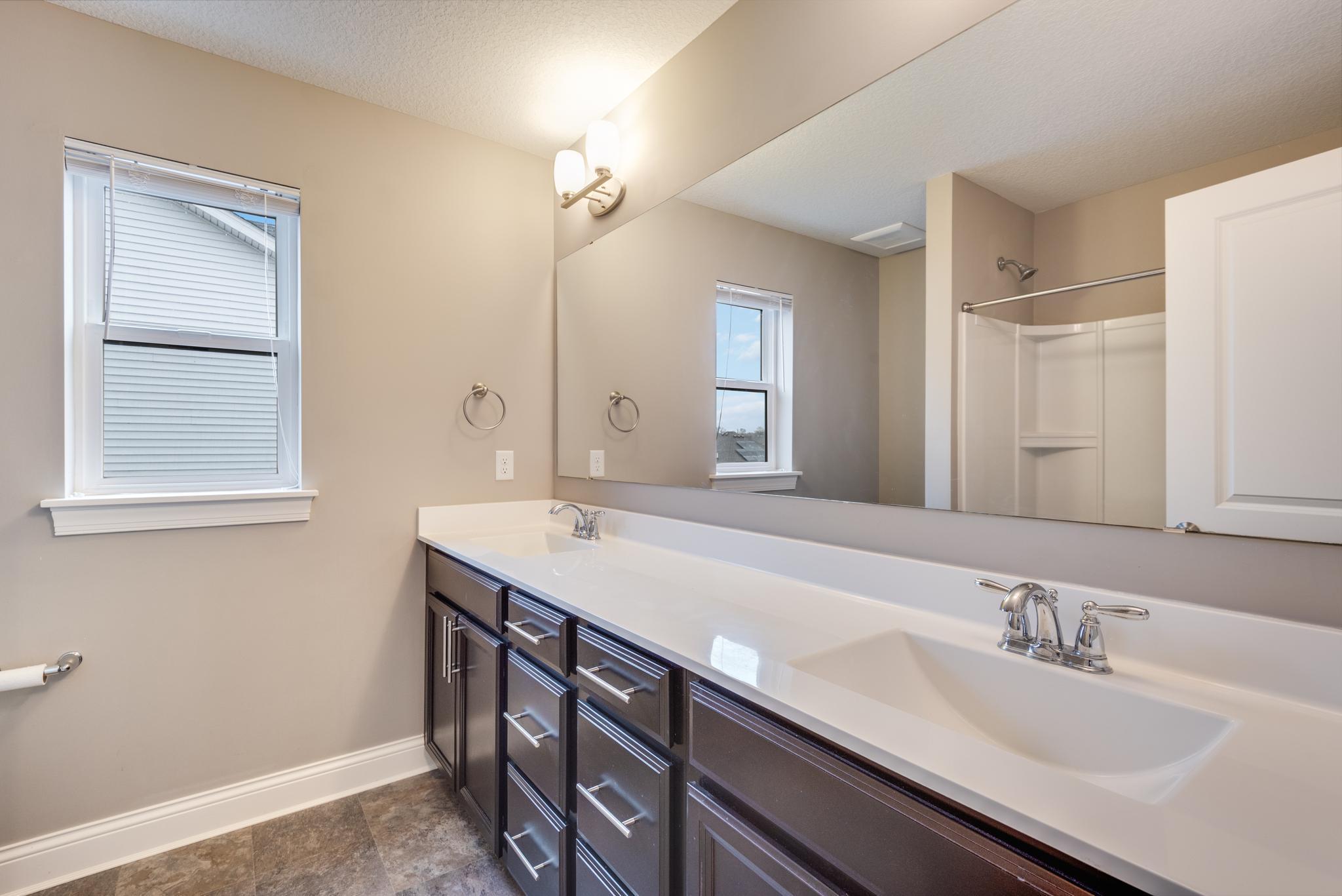 Upper level full bath with shower/tub combo and dual sinks