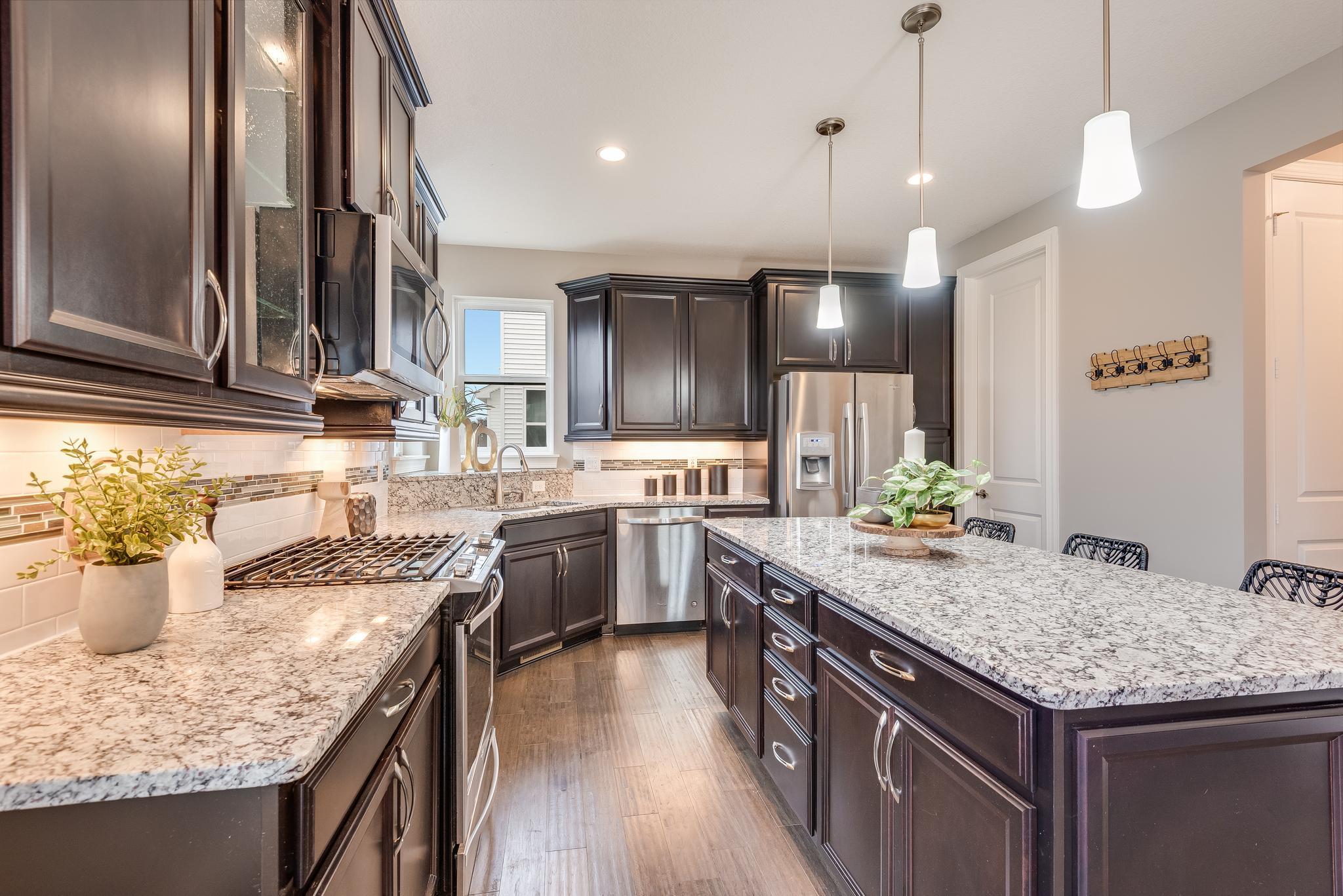 Gourmet kitchen with granite countertops and island with seating
