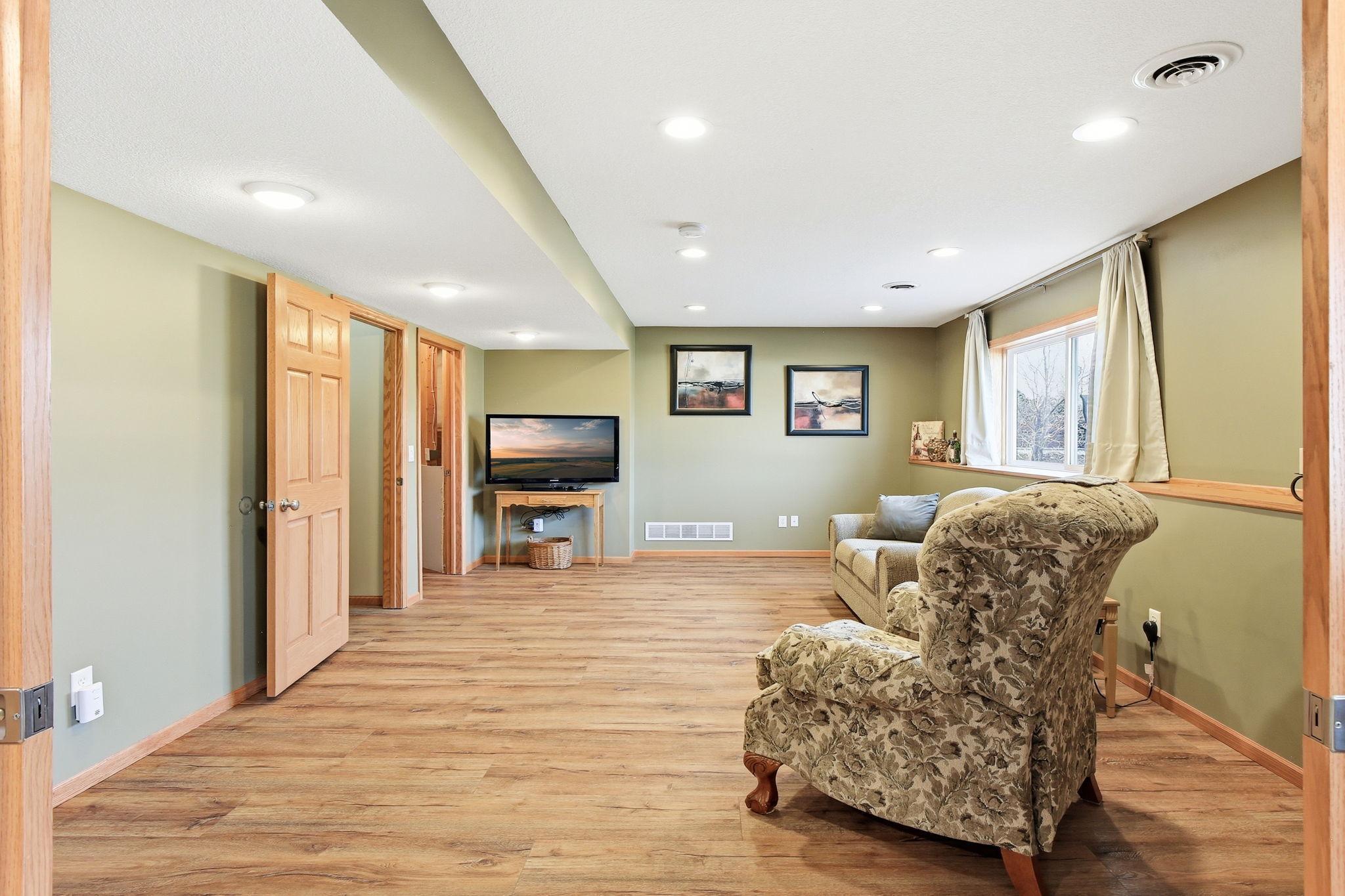 Family Room has newer LVP flooring, recessed lights and large lookout windows.