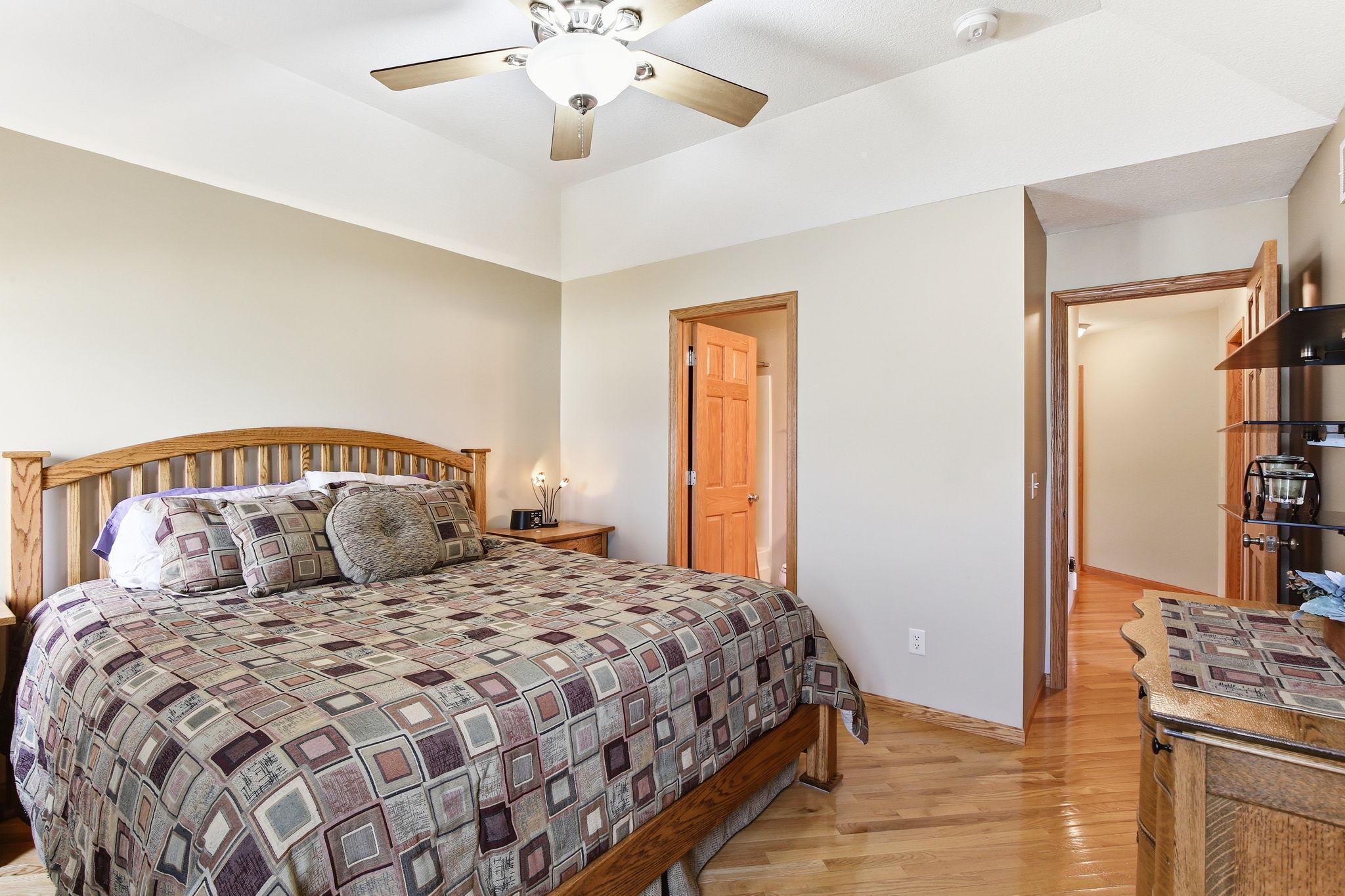 Primary Bedroom has hardwood floors, a walk-in closet and a private bath.