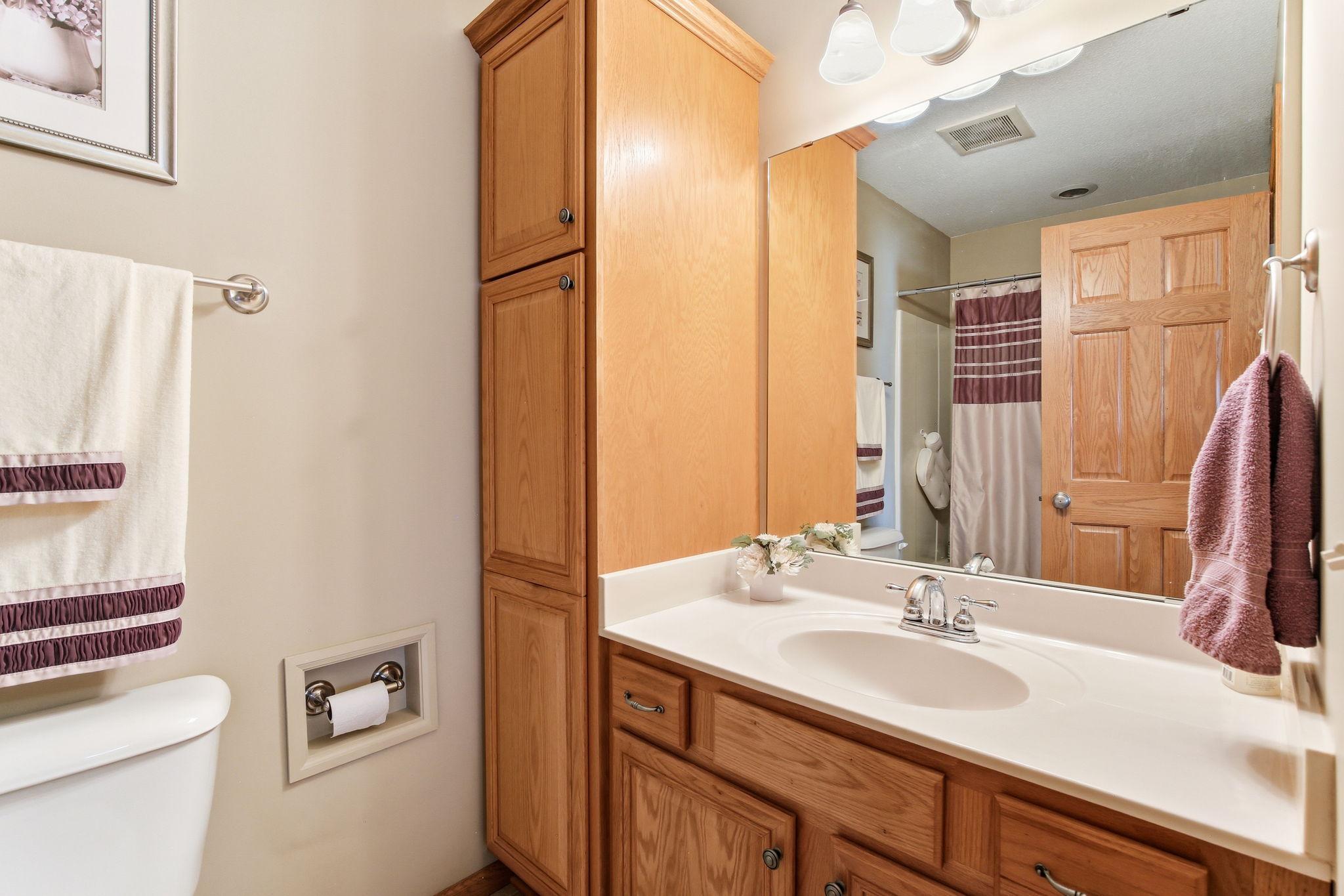 Primary Bathroom has a tub with jacuzzi and tile floors.