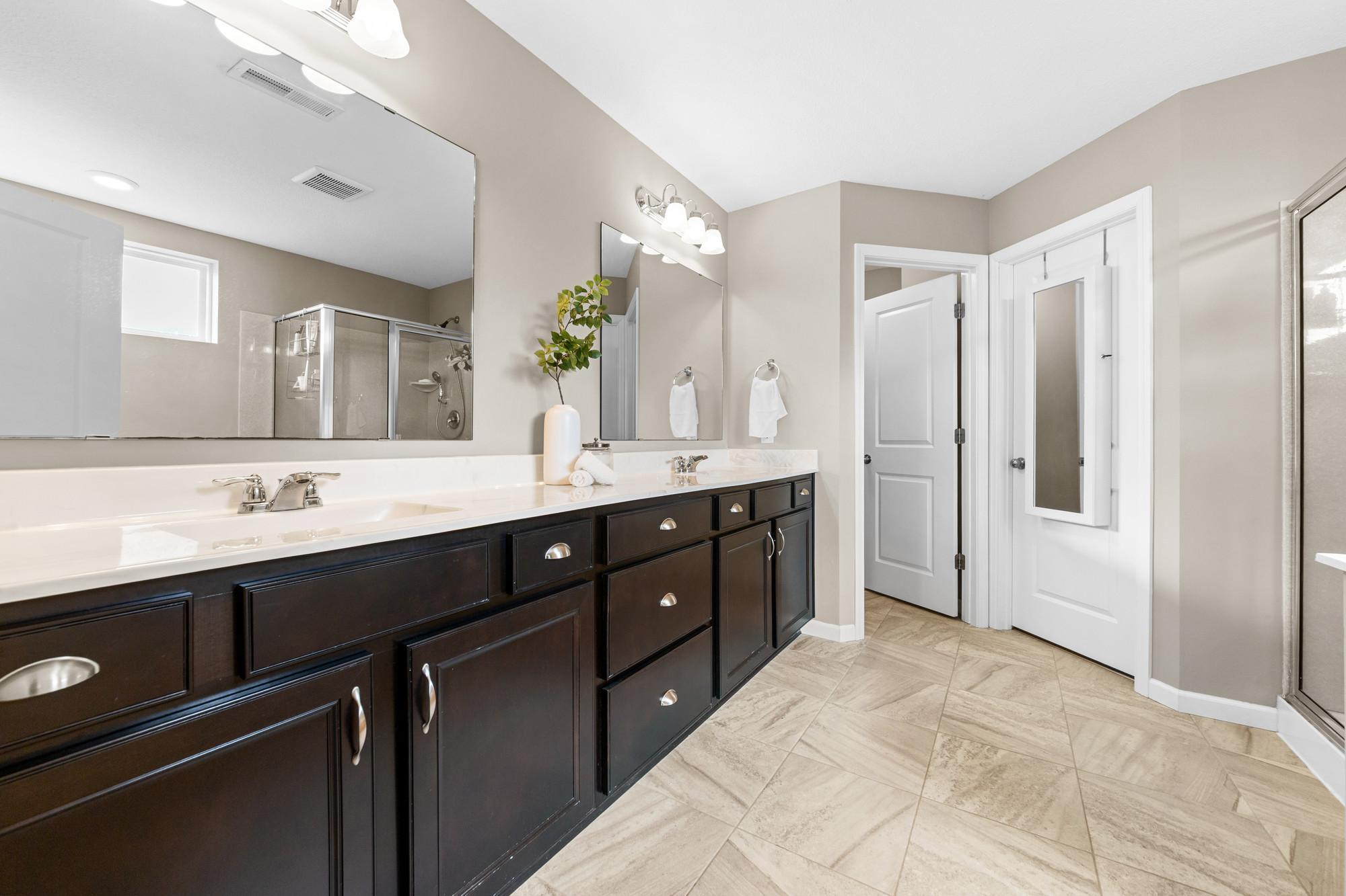 Beautiful primary bath with upgraded counters, walk in shower and tub