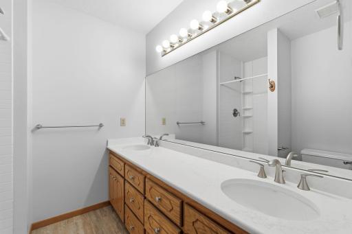 The en suite bathroom has double sink set-up with tons of countertop space