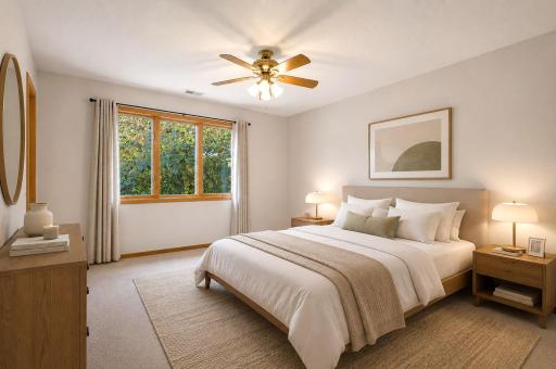 The upstairs primary bedroom offers an en suite bathroom and walk in closet (virtually staged)