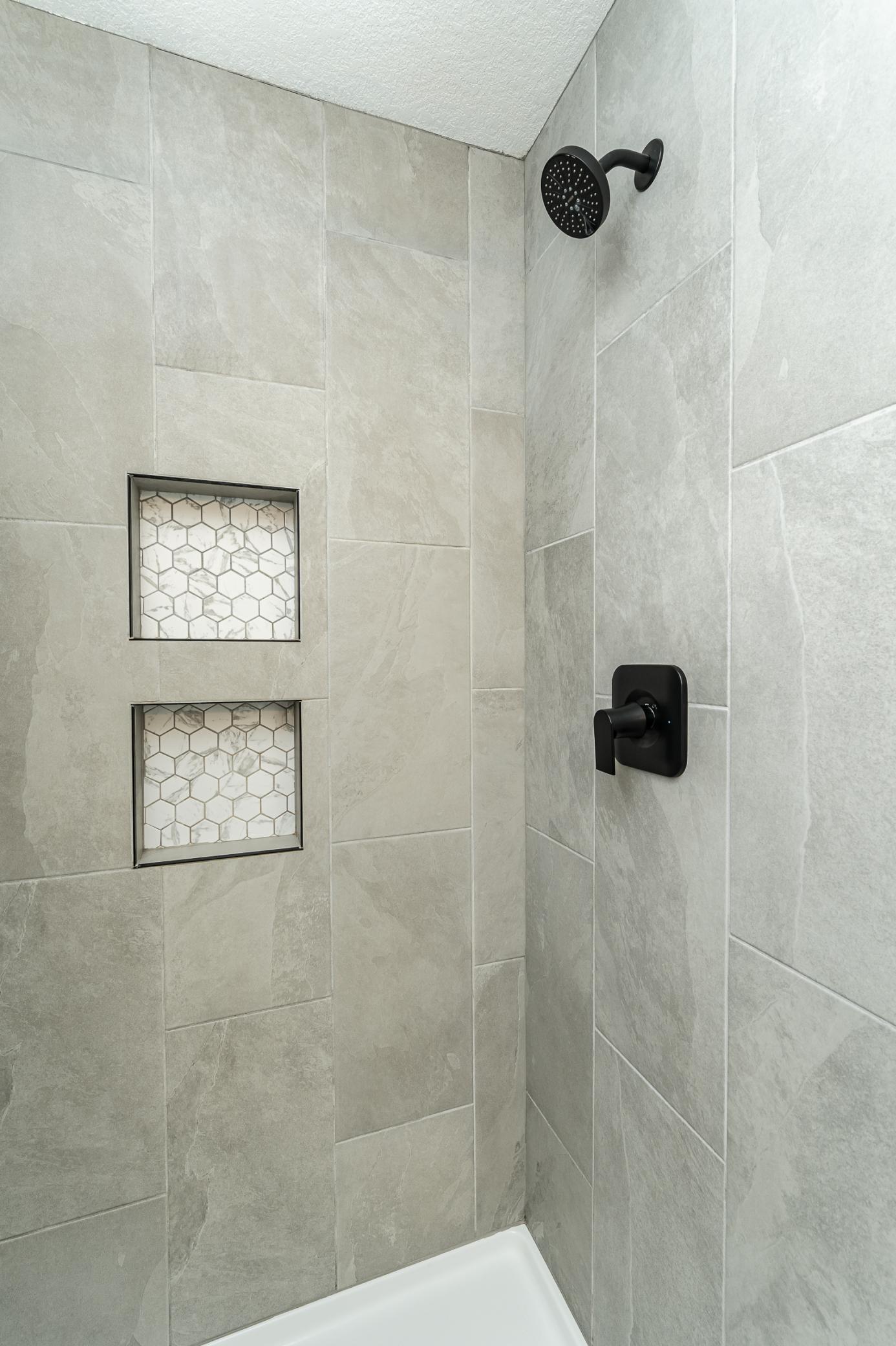 Tiled recessed shower niches.