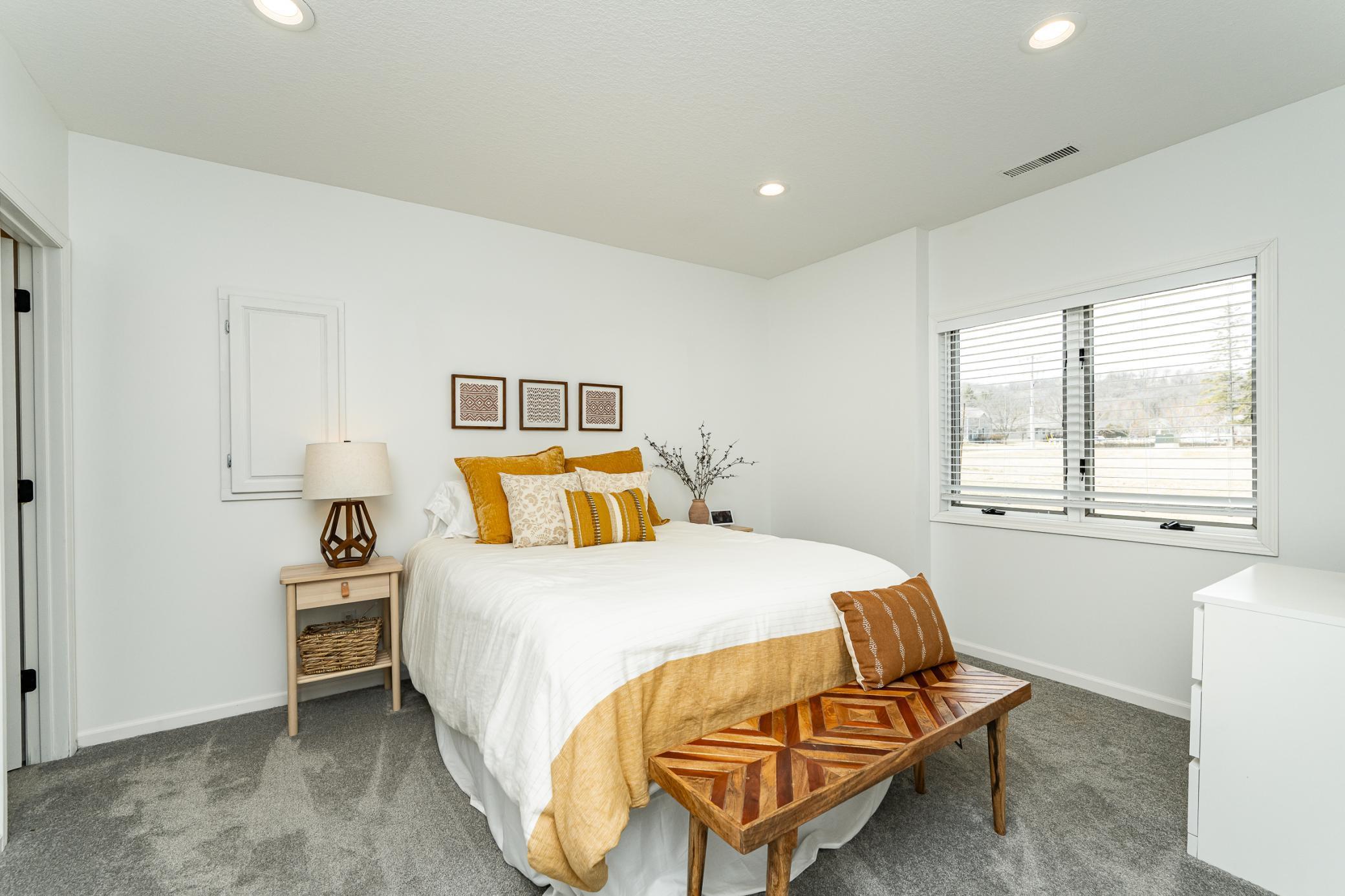 Bedroom five with wood blinds is very spacious and has a walk in closet.