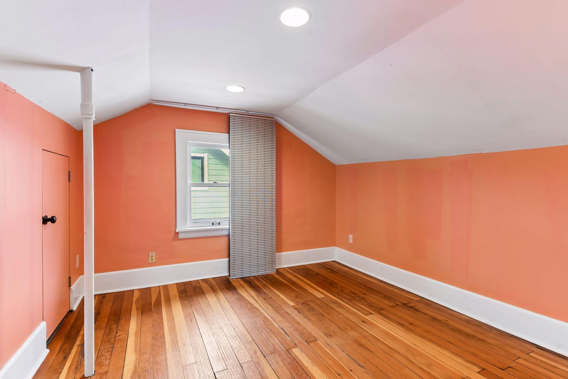One of 2 upper floor bedrooms with solid wood flooring.