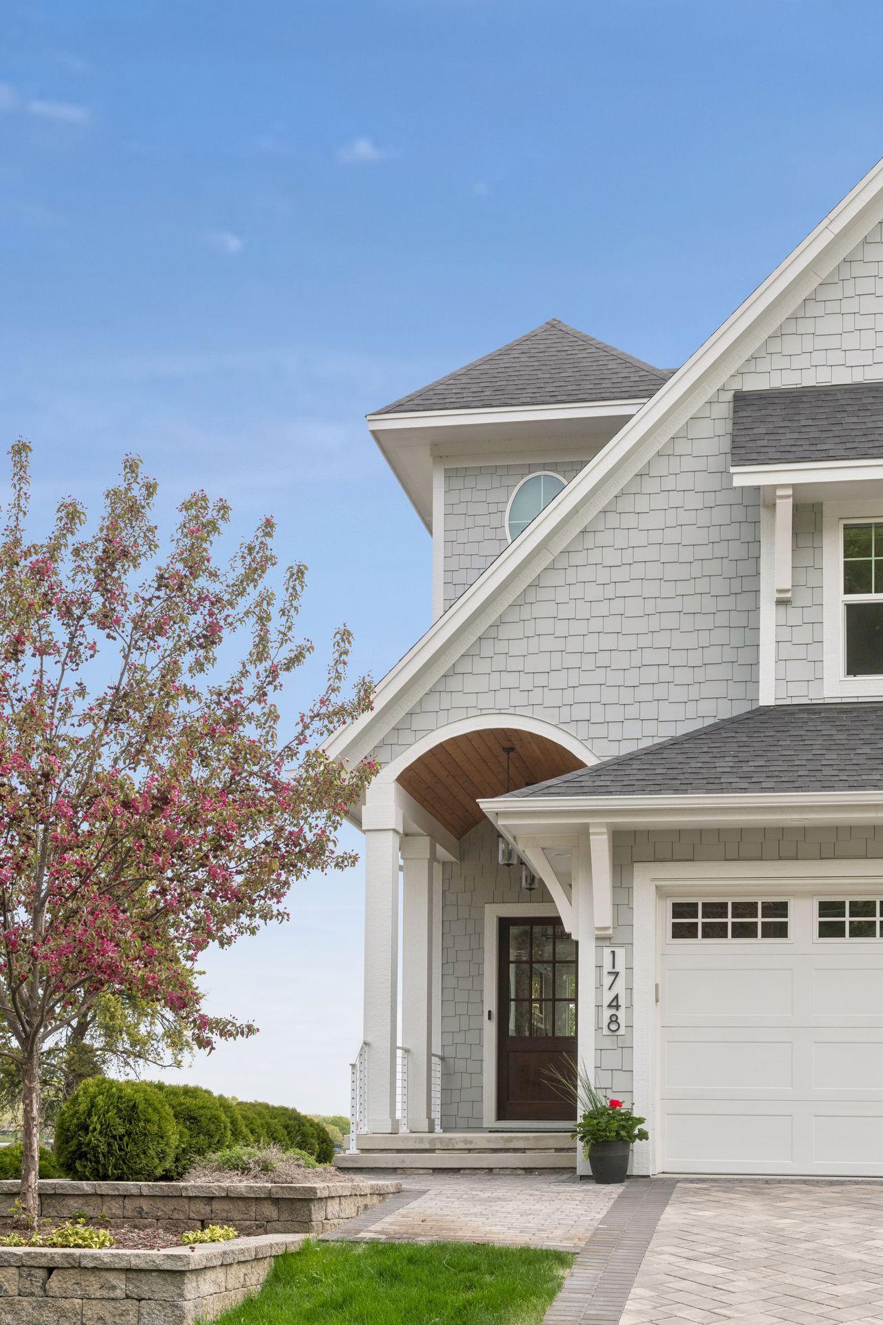 A grand barrel-vaulted entryway features intricate beadboard detailing and stately columns, setting a tone of coastal sophistication for this custom retreat.