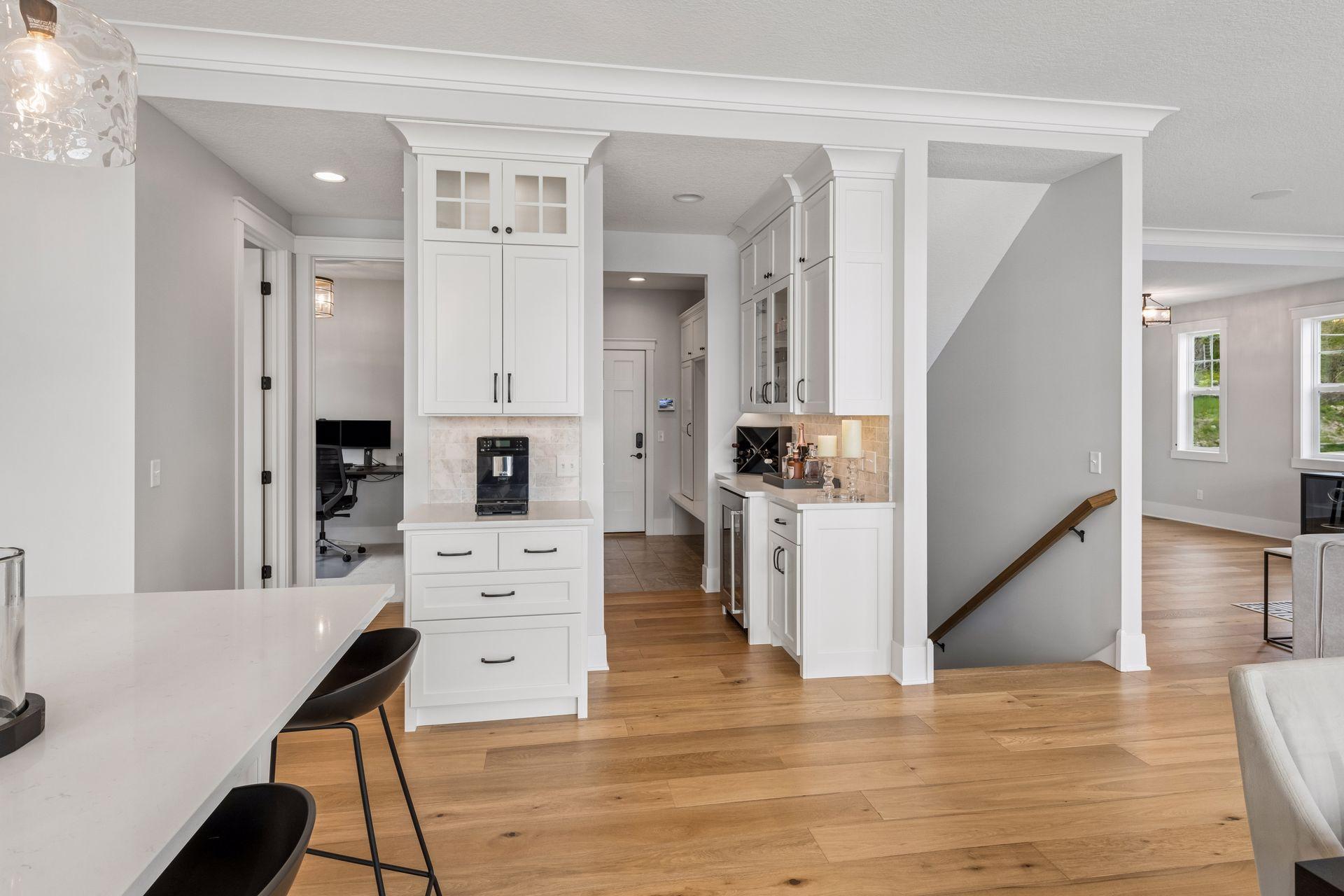 A dedicated preparation area features a built-in wine refrigerator and abundant custom cabinetry, ensuring effortless hosting for any occasion