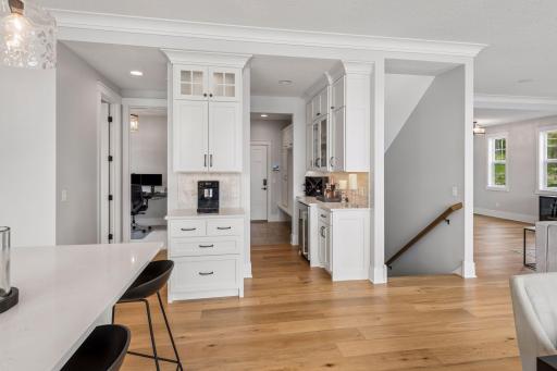 A dedicated preparation area features a built-in wine refrigerator and abundant custom cabinetry, ensuring effortless hosting for any occasion.