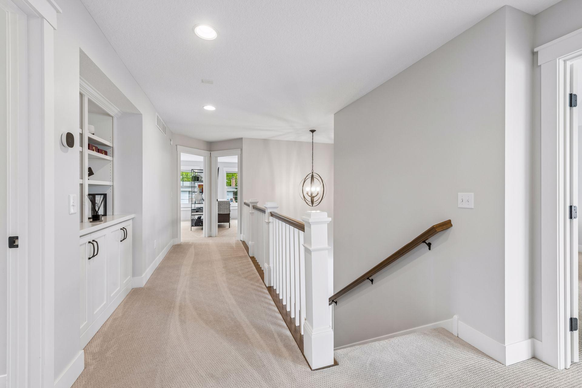 The upper level features three spacious bedroom suites, each thoughtfully designed with its own private ensuite bathroom and a generous walk-in closet