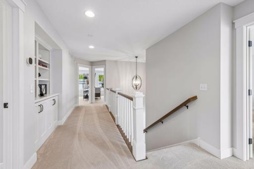 The upper level features three spacious bedroom suites, each thoughtfully designed with its own private ensuite bathroom and a generous walk-in closet.