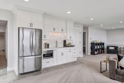 Serve drinks and snacks from the stylish kitchenette while hosting guests by the water.