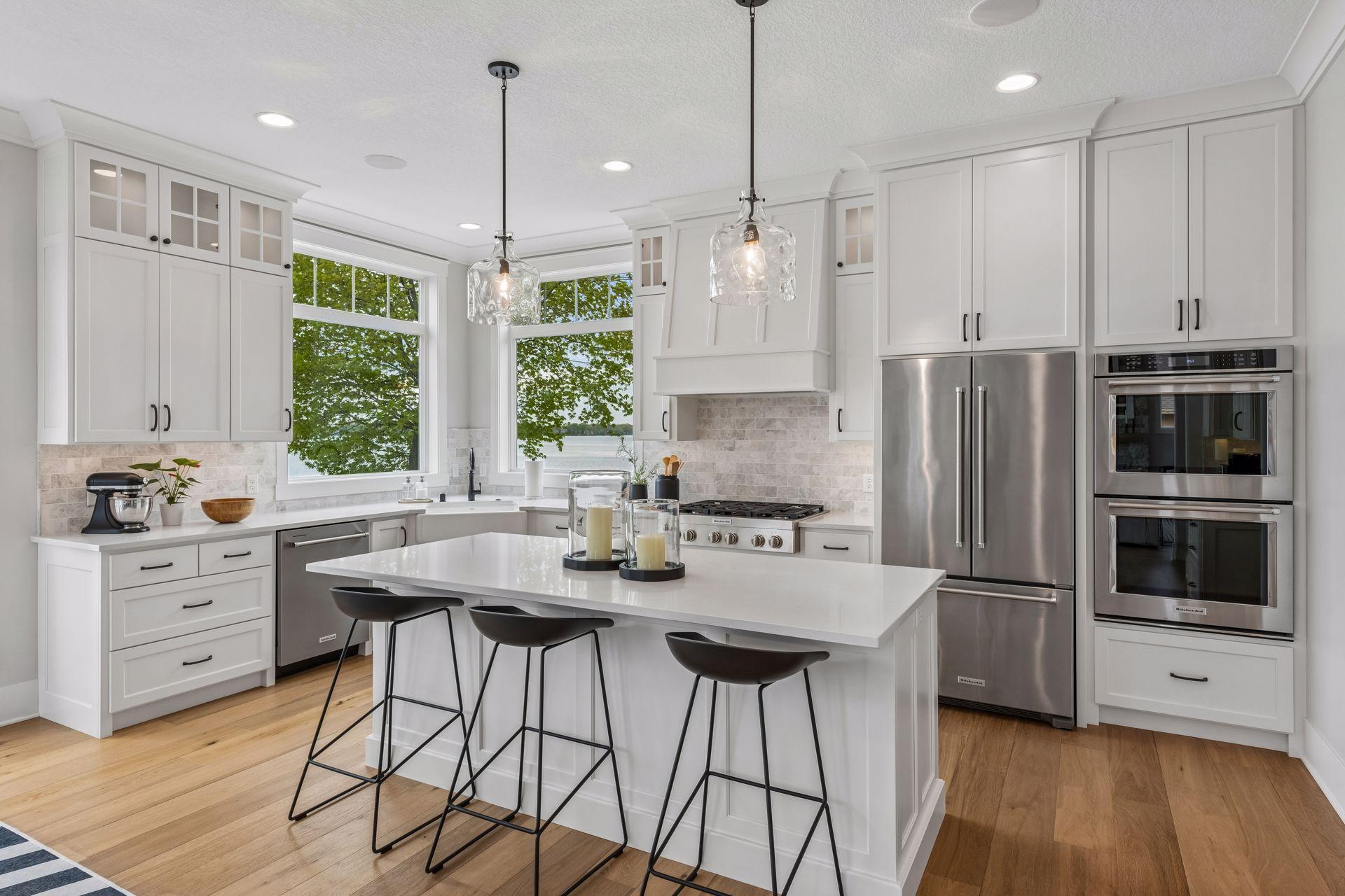 The chef’s kitchen shines with an oversized quartz island, marble backsplash, and premium appliances