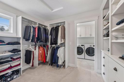 Expansive boutique-style walk-in closet provides exceptional storage and organization.