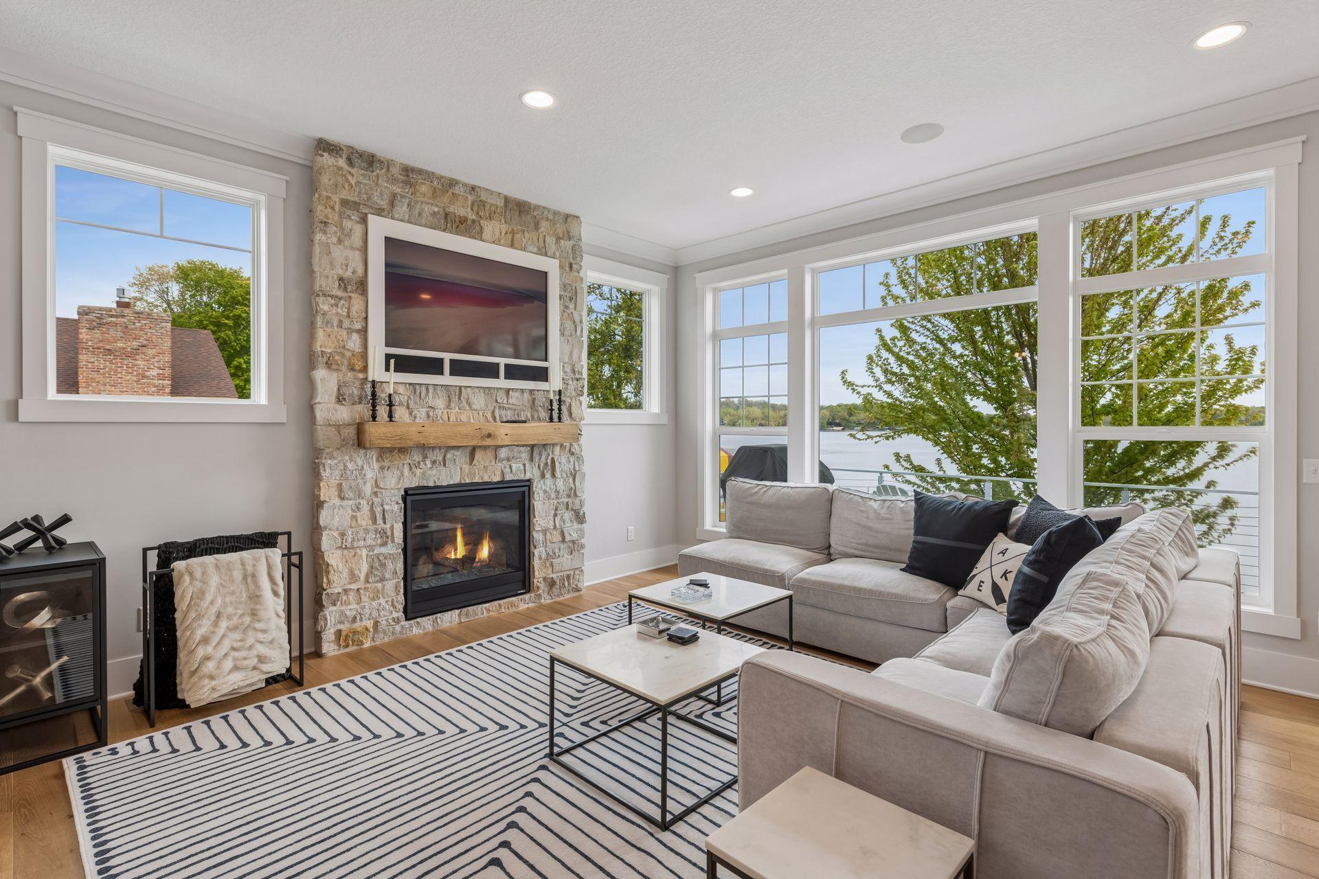 Soaring stone fireplace with rustic mantle add texture and warmth