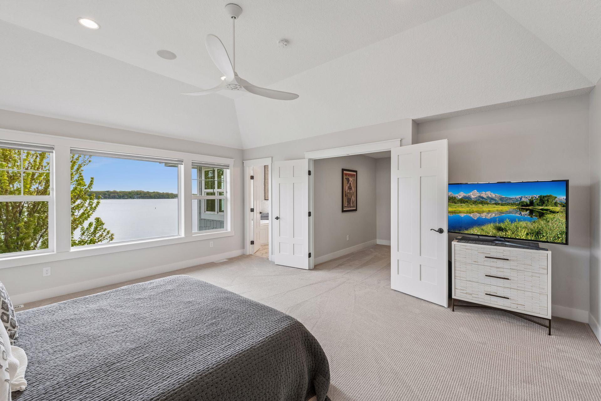 Step through classic French doors into a dedicated dressing wing, featuring a massive walk-in closet designed for the ultimate wardrobe collection