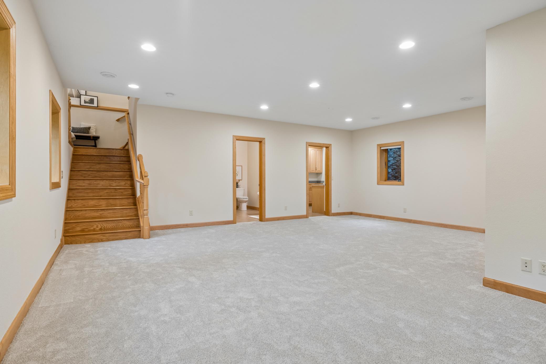 The open-concept layout provides ample room for multiple seating areas, game tables, workout space, or future recreation space