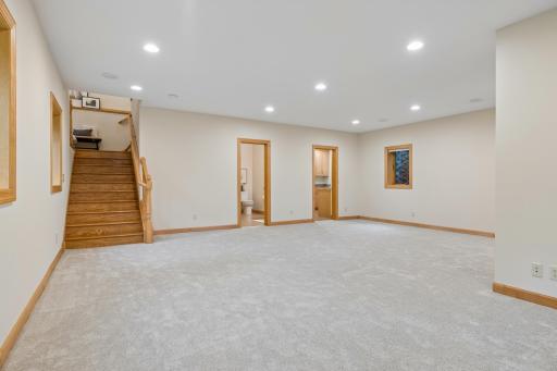 The open-concept layout provides ample room for multiple seating areas, game tables, workout space, or future recreation space