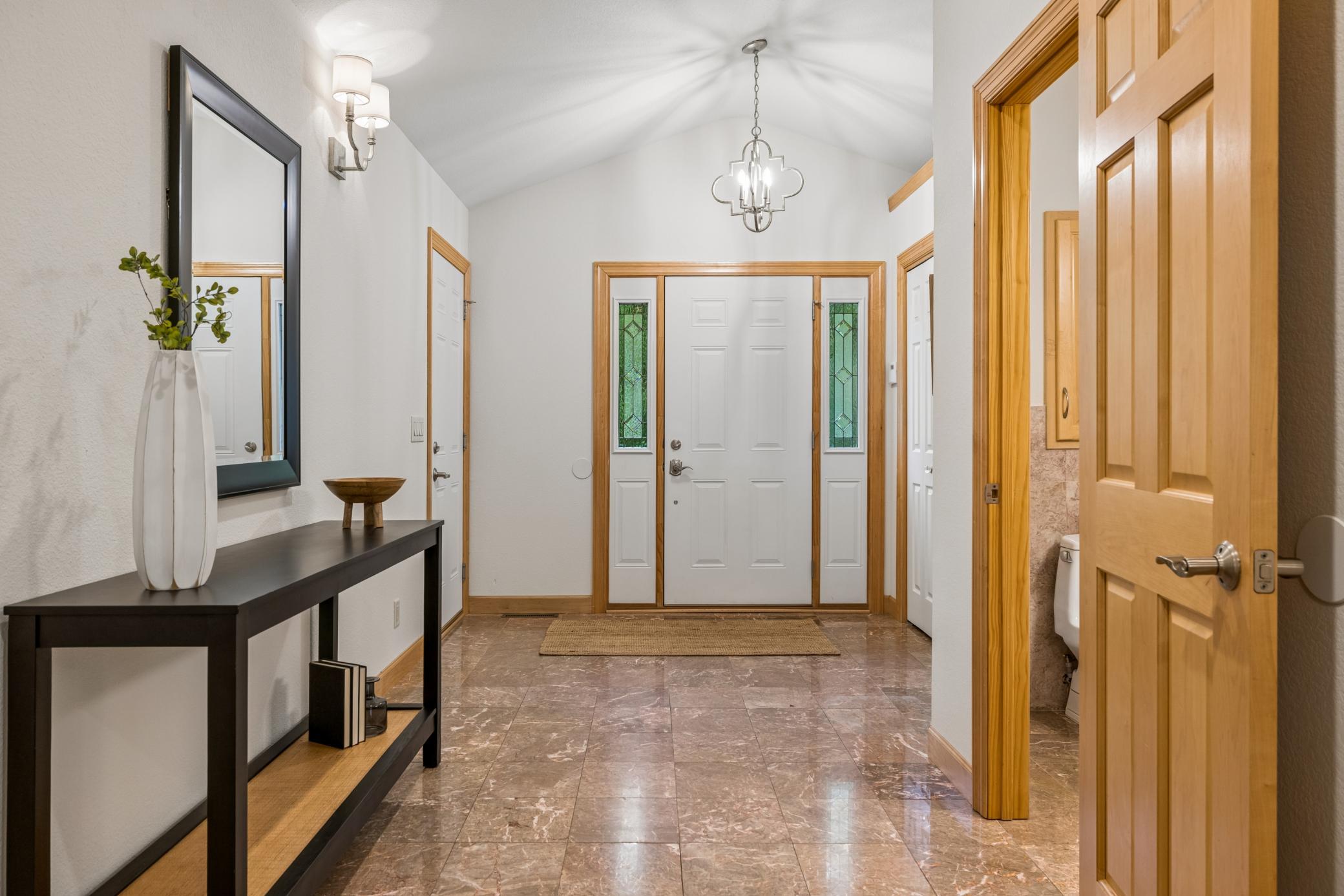 Large welcoming foyer with elegant marble flooring .