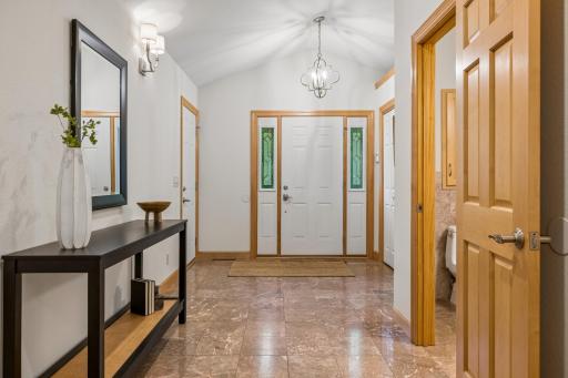 Large welcoming foyer with elegant marble flooring .