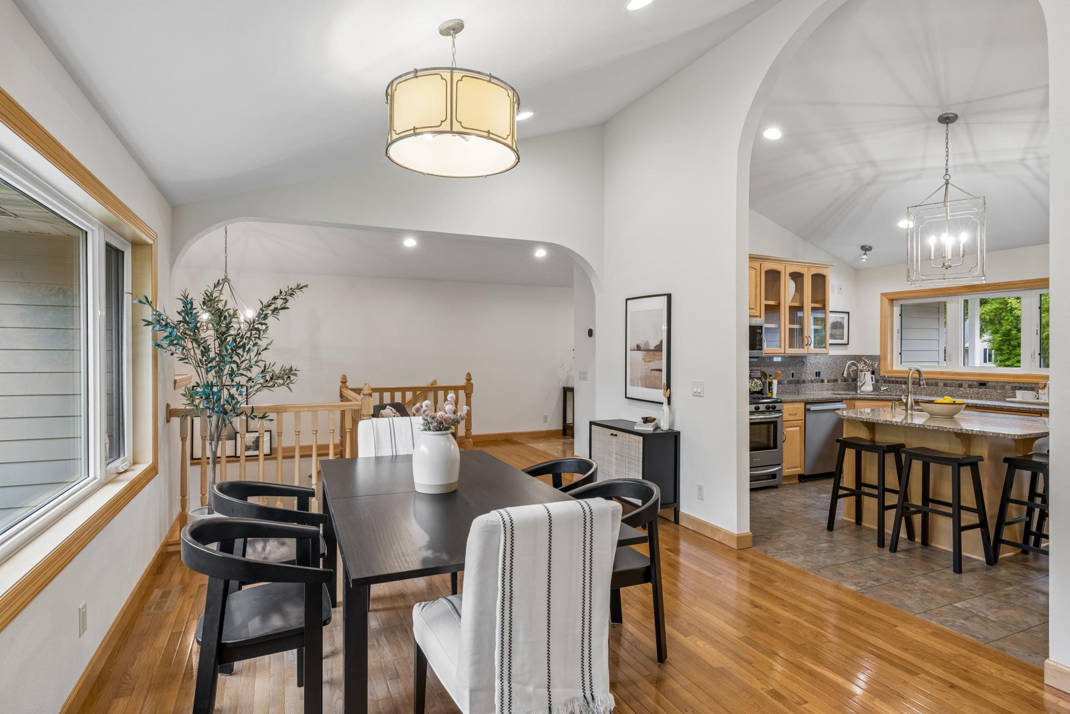A dramatic high archway leads into the kitchen.
