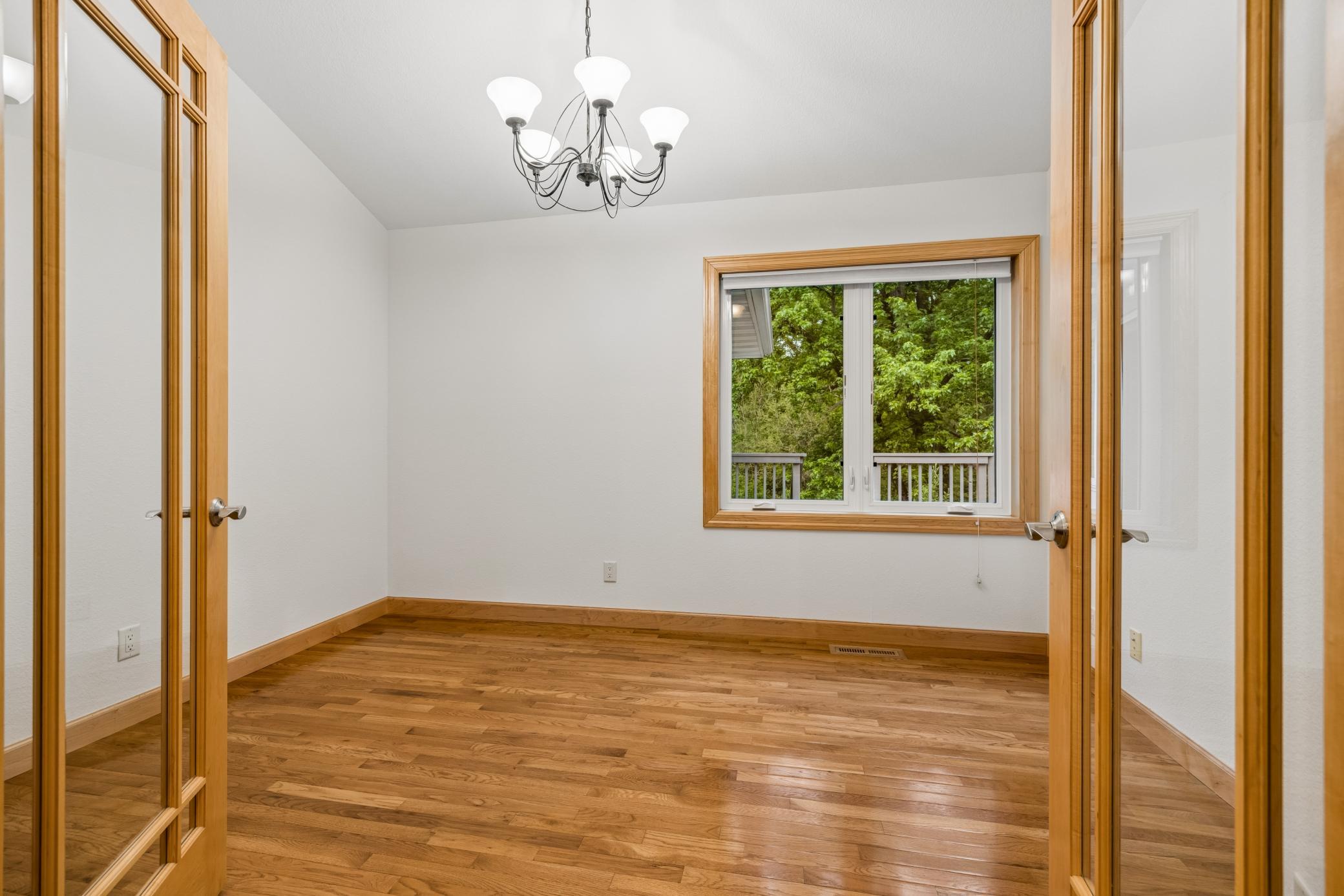 French doors lead to a private office, creating the perfect setup for working from home or a quiet retreat.