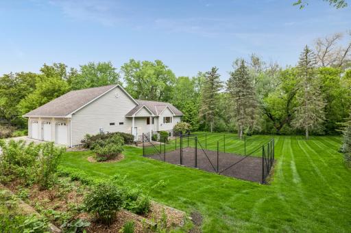 Mature trees, expansive lawn space, & a large fenced garden.