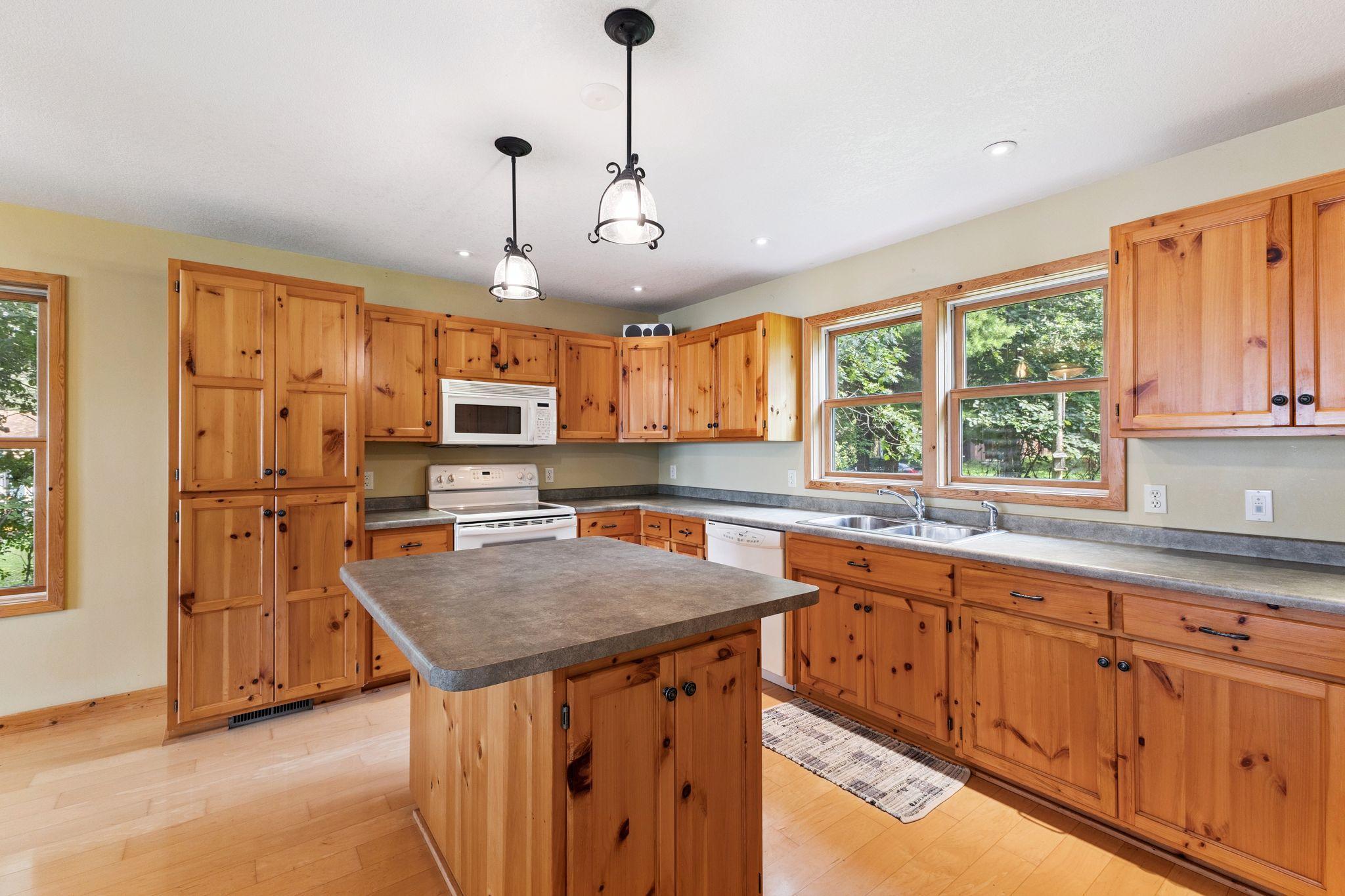 Beautiful knotty pine cabinets and wood floor in the kitchen