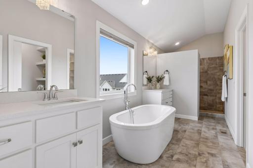 Primary bath with separate soaking tub and walk in tile shower
