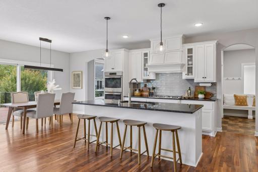 Chef's kitchen opens to sunroom, mudroom and half bath