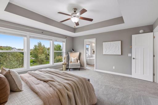 Primary suite opens to luxurious primary bath