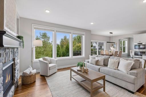 Living room and dining room with serene pond views