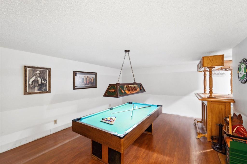 Spacious lower-level entertainment area complete with built-in bar space and room for a pool table or media setup.