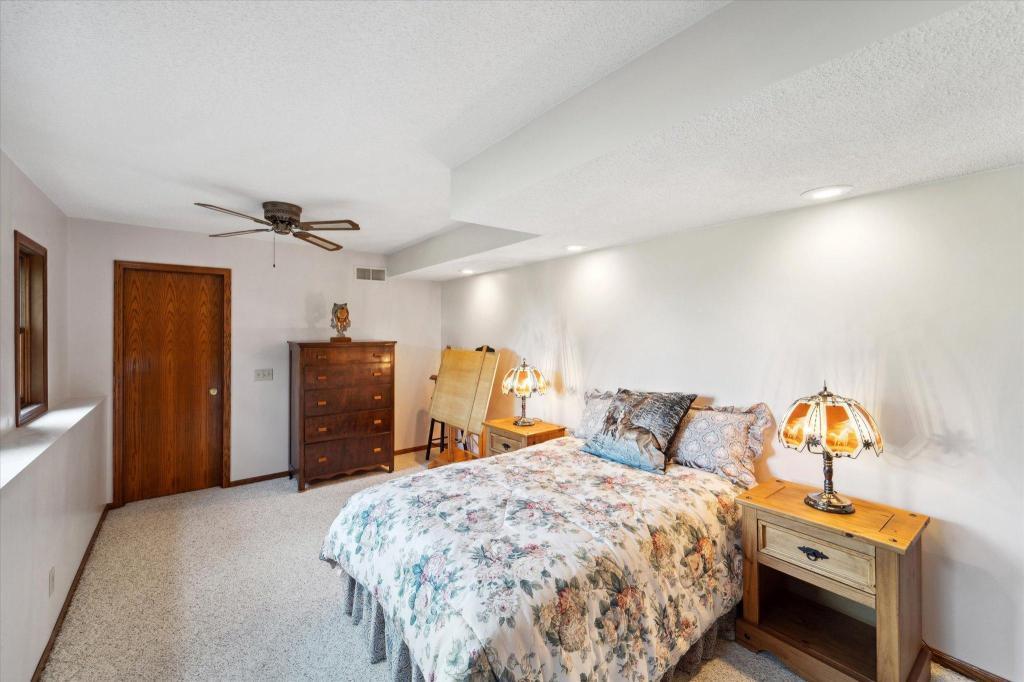 Large secondary lower-level bedroom with scenic countryside views and comfortable living space.